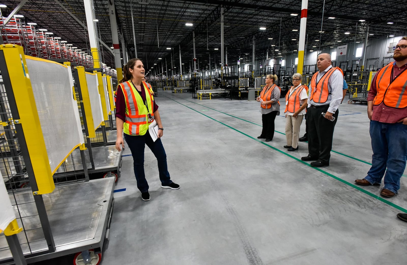 Amazon Fulfillment Center general manager Jane Tschanen leads a tour of the facility Tuesday, Aug. 28 in Monroe. The Amazon Fulfillment Center in Monroe is the largest building in the city at 1.3 million square feet. The facility is expected to be operating by early 2019 and could bring one thousand jobs to the community. NICK GRAHAM/STAFF