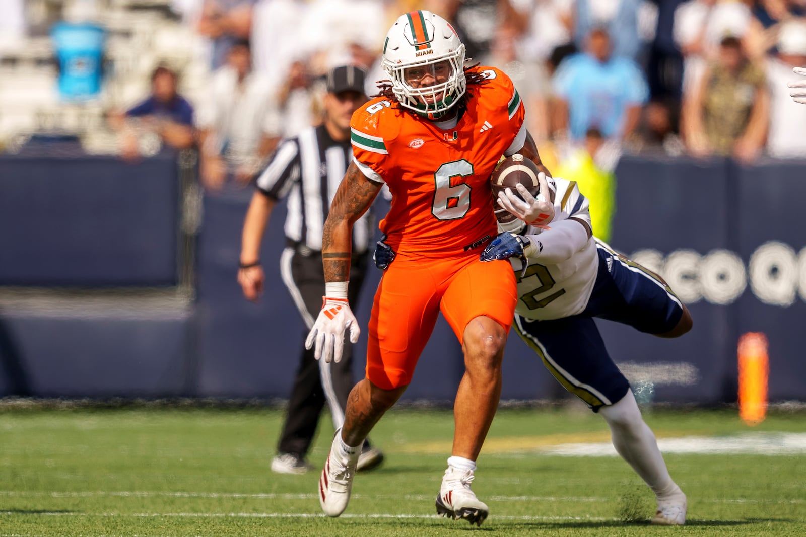 Miami running back Damien Martinez (6) runs the ball during the first half of an NCAA college football game against Georgia Tech, Saturday, Nov. 9, 2024, in Atlanta. (AP Photo/Jason Allen)