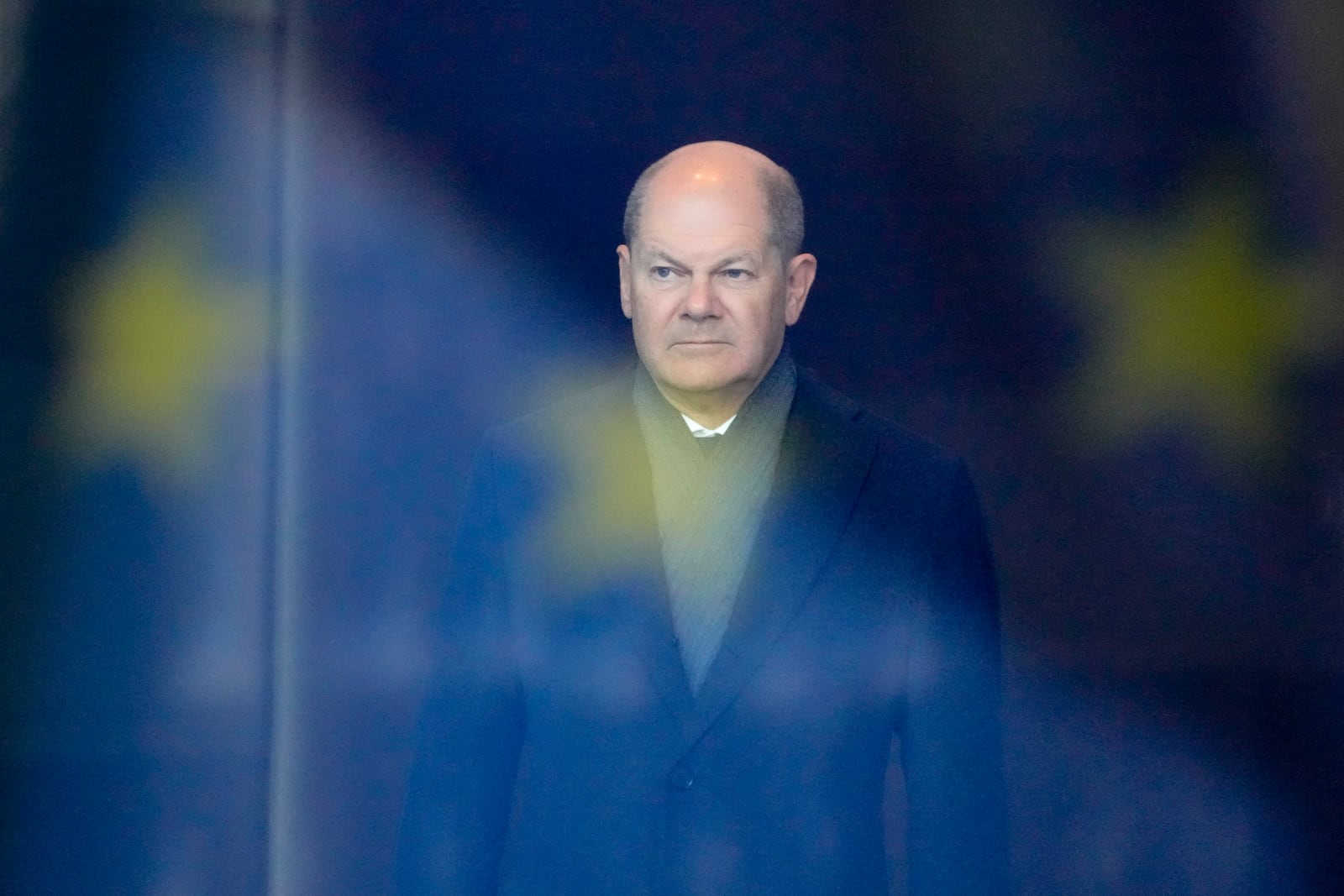 FILE - German Chancellor Olaf Scholz stands behind a reflection of the European flag in a window, as he waits for the arrival of Iraq's Prime Minister Mohamed Shia al-Sudani at the chancellery in Berlin, Germany, Jan. 13, 2023. (AP Photo/Markus Schreiber, File)