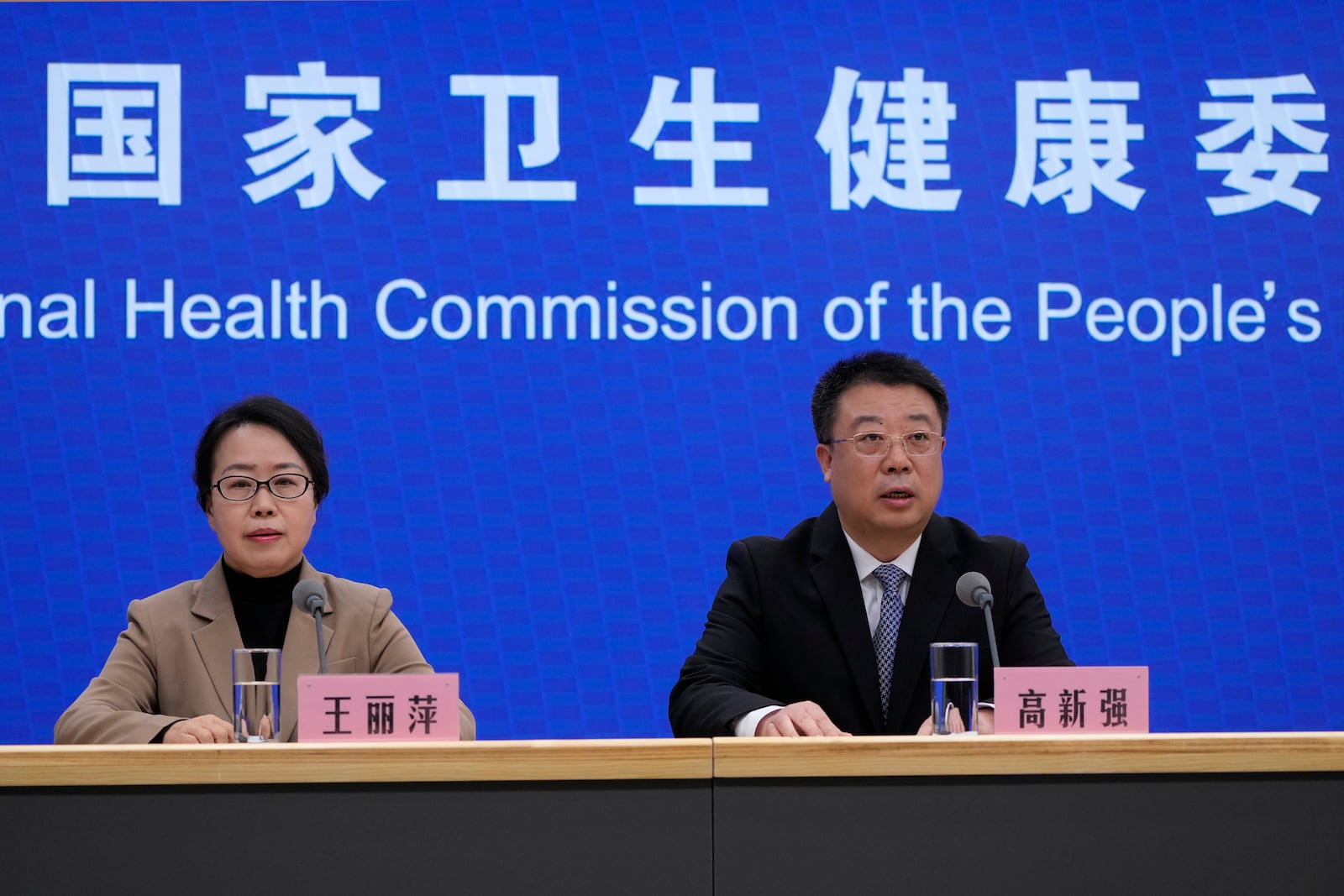 Gao Xinqiang, deputy director of the Department of Medical Emergency Response of the health commission, right, speaks next to Wang Liping, researcher for the Chinese Center for Disease Control and Prevention during a press briefing by the National Health Commission as concerns surfaced in recent days over a surge in human metapneumovirus (HMPV) infections in northern China after images circulated online of hospitals overrun with masked patients, in Beijing, Sunday, Jan. 12, 2025. (AP Photo/Andy Wong)