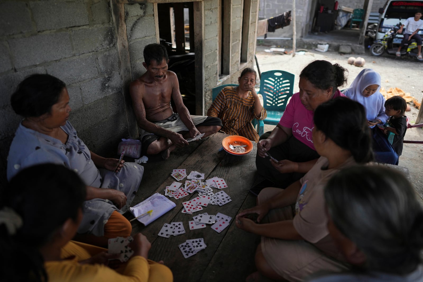 People play cards in Budong-Budong, West Sulawesi, Indonesia, Monday, Feb. 24, 2025. (AP Photo/Dita Alangkara)