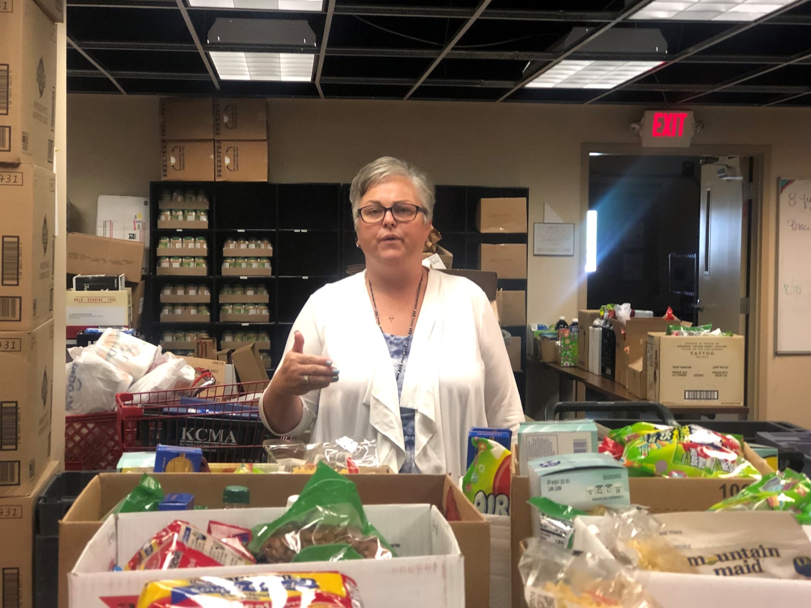 Michelle Collier in Good Neighbor House's food pantry area. Collier is the chief operating officer of the nonprofit. CORNELIUS FROLIK / STAFF