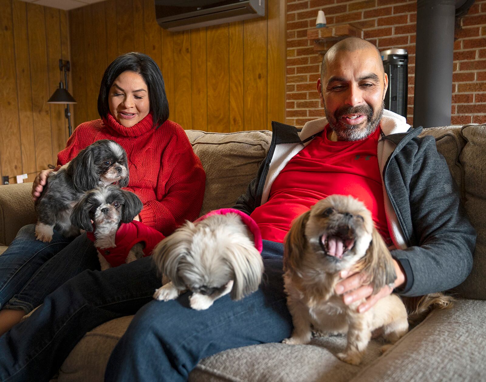 Dahlia and Jerry Garcia relax at home in Centerville with their four dogs (from left) Duke, Khloe, Mia and Osita on Dec. 23. Dahlia, an Air Force captain and registered nurse, works the night shift at Wright-Patterson Medical Center’s Labor and Delivery Ward. She usually needs to sleep during the day but gets up midday to spend a couple of hours with Jerry before going back to bed. U.S. AIR FORCE PHOTO/R.J. ORIEZ