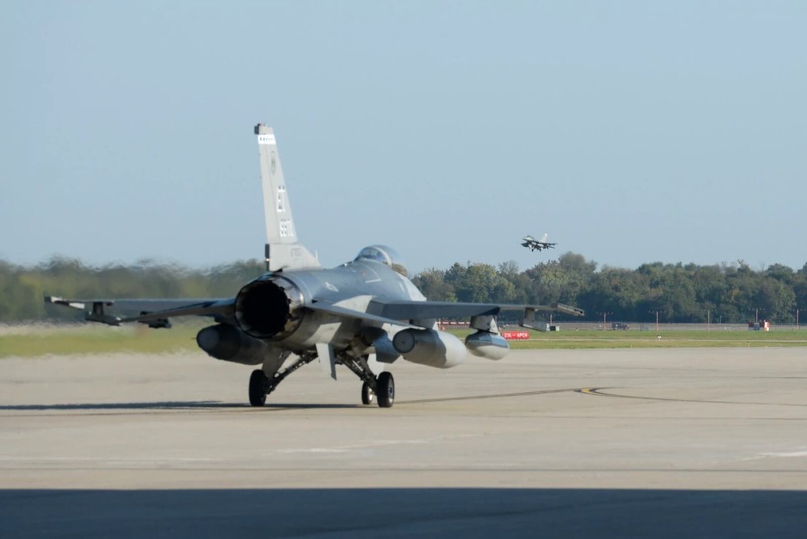 An F-16 Fighting Falcon from Eglin Air Force Base, Fla., taxis while another one prepares to land on the runway at Wright-Patterson Air Force Base in preparation for landing and safe haven on Oct. 9, 2018. (U.S. Air Force photo by Wesley Farnsworth)