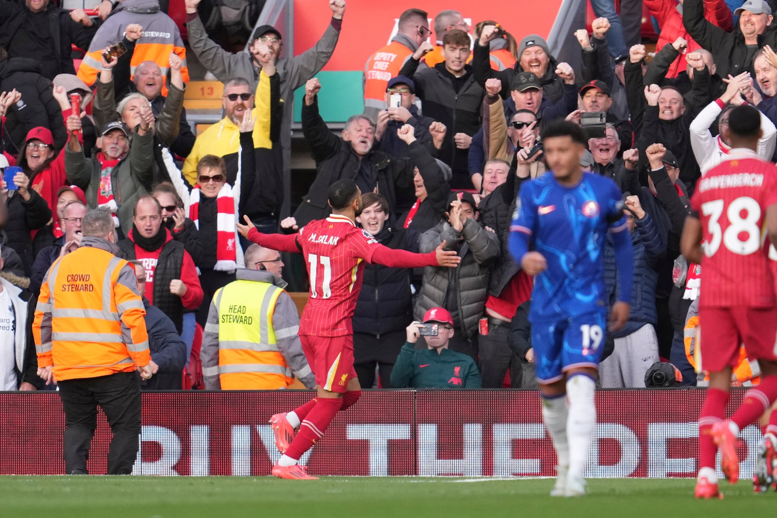 Liverpool's Mohamed Salah, centre, celebrates after scoring his side's opening goal during the English Premier League soccer match between Liverpool and Chelsea at Anfield Stadium, Liverpool, England, Sunday, Oct. 20, 2024. (AP Photo/Jon Super)