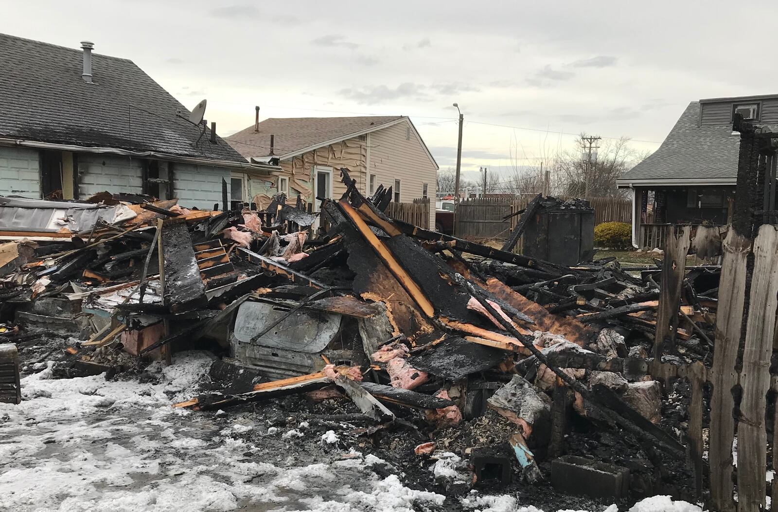 Damage is shown Dec. 12, 2018, following a fire that broke out the day before on South Street in Piqua that destroyed a garage and damaged several other garages and homes.