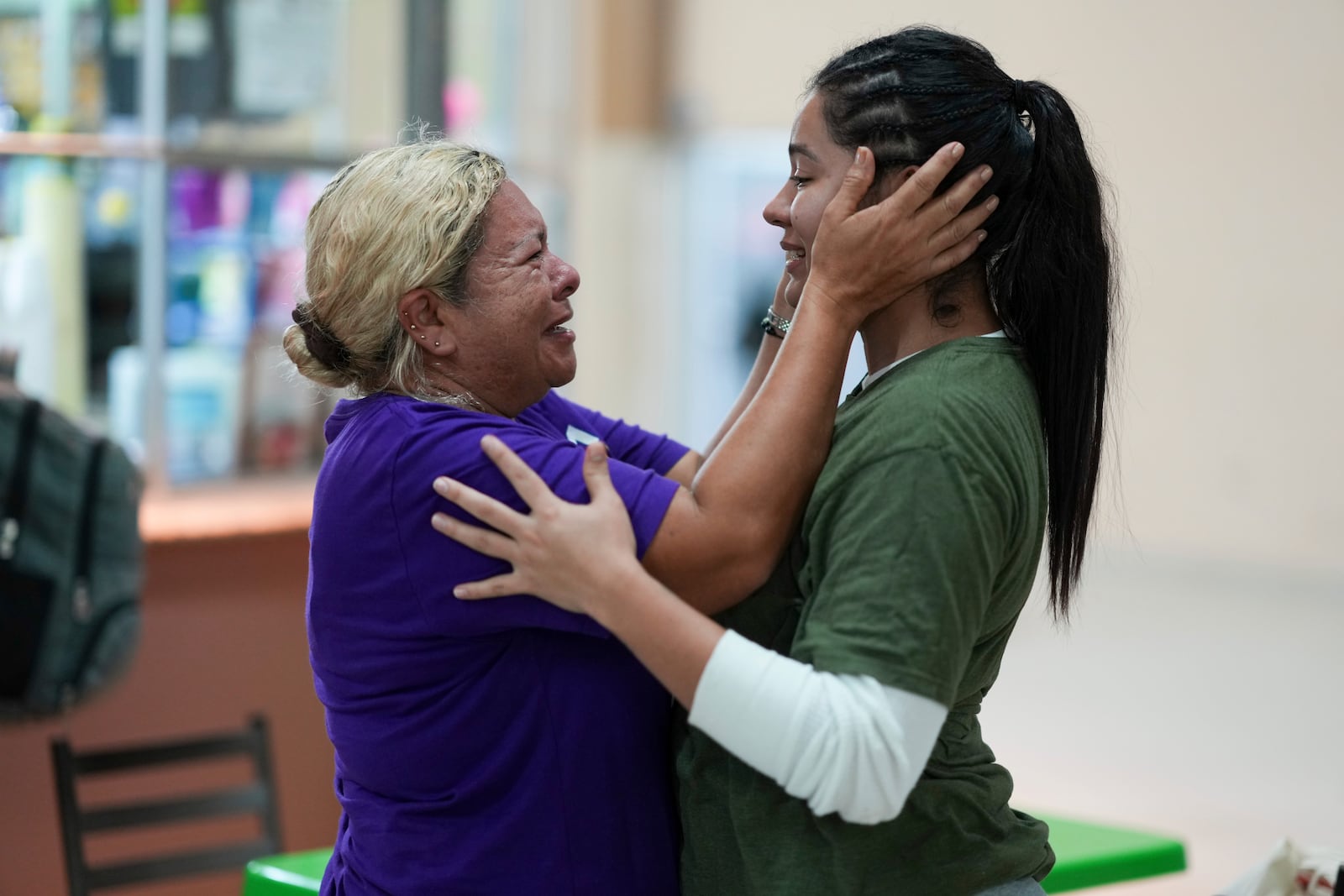 Honduran migrant Kimberly Orellana, right, greets her mother Oralia Mejía after being deported from the U.S., at a bus station in San Pedro Sula, Honduras, Wednesday, Dec. 4, 2024. (AP Photo/Moises Castillo)