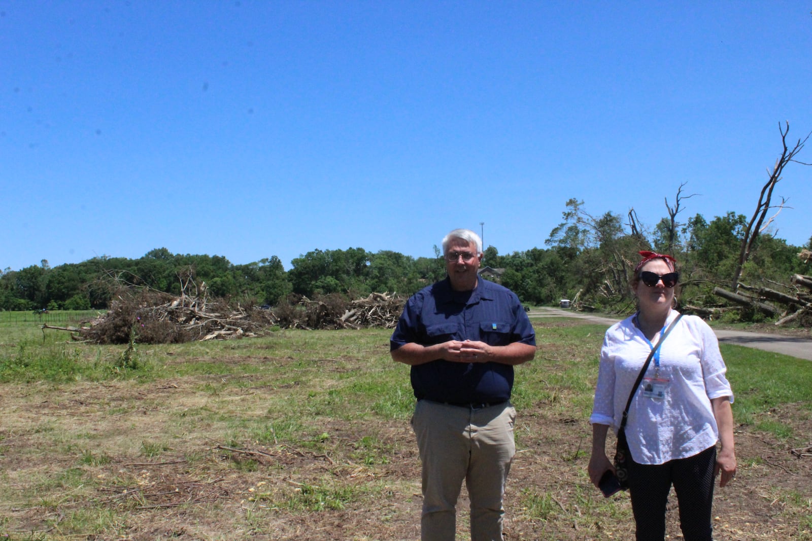 Chris Pion, Five Rivers MetroPark’s director of parks and conservation,  and Kristen Wicker, the park system's marketing manager, look at tree damage near Wegerzyn MetroPark's community garden plots.