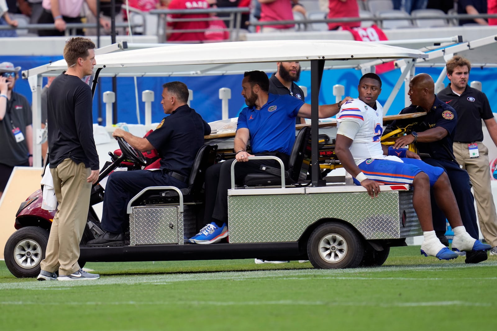 Florida quarterback DJ Lagway, right, leaves the field on a cart after he was injured during the first half of an NCAA college football game against Georgia, Saturday, Nov. 2, 2024, in Jacksonville, Fla. (AP Photo/John Raoux)