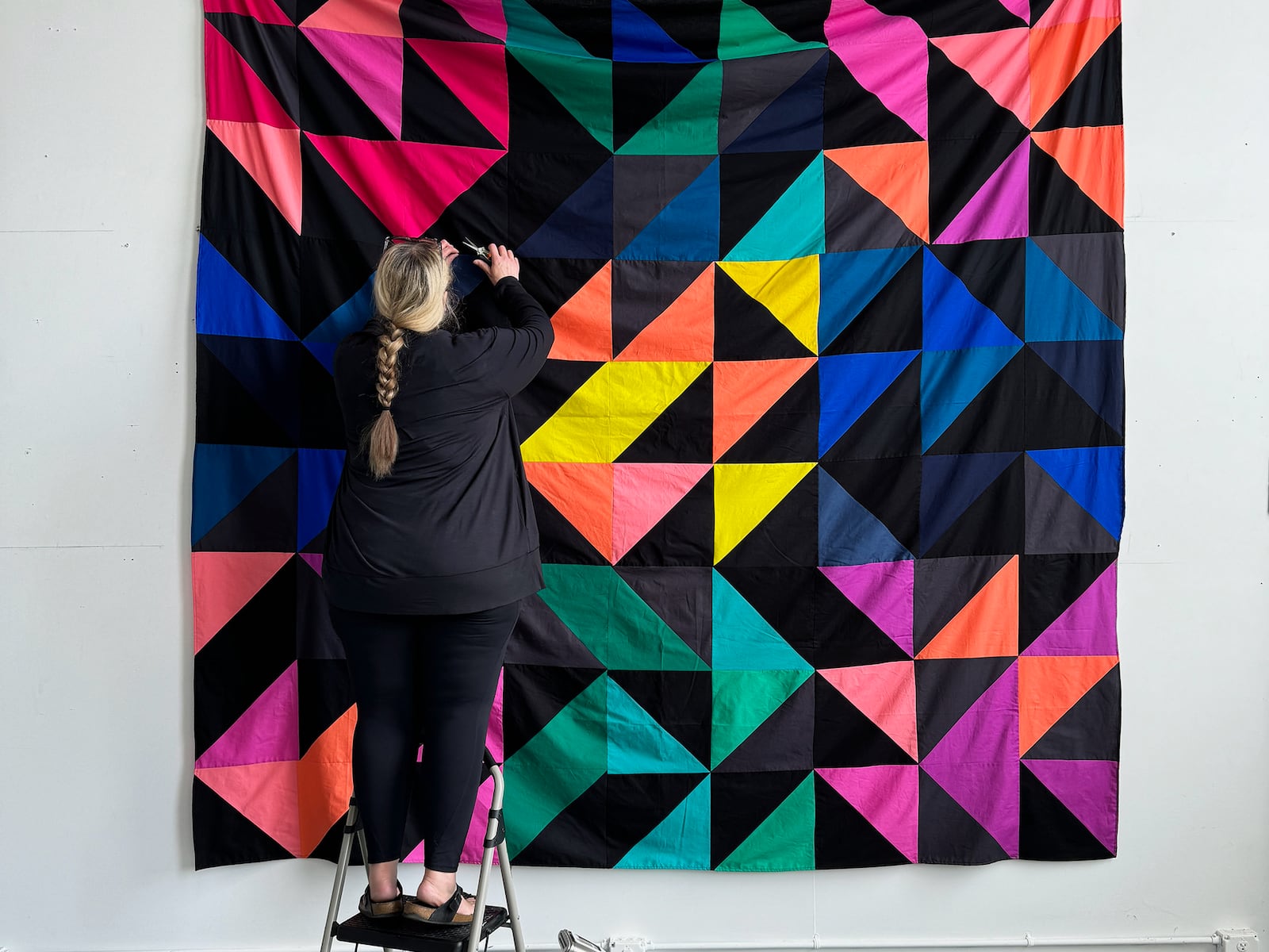 Heather Jones at work in her Front Street studio. The artist exhibits and participates in residencies widely. Her art combines quilting practices with feminism and art history.