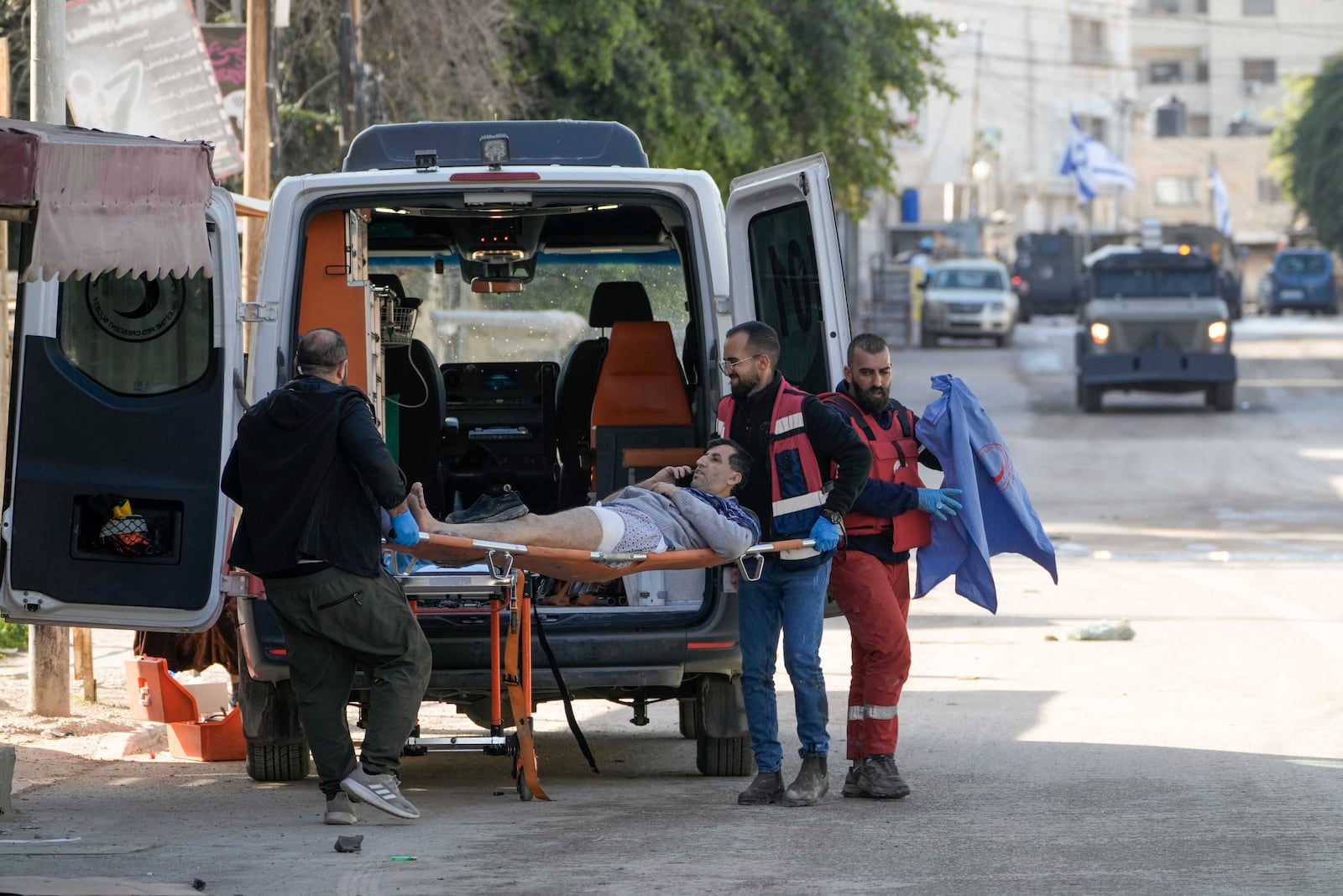 Medics evacuate a wounded man during an Israeli military operation in the West Bank city of Jenin, Tuesday, Jan. 21, 2025. (AP Photo/Majdi Mohammed).