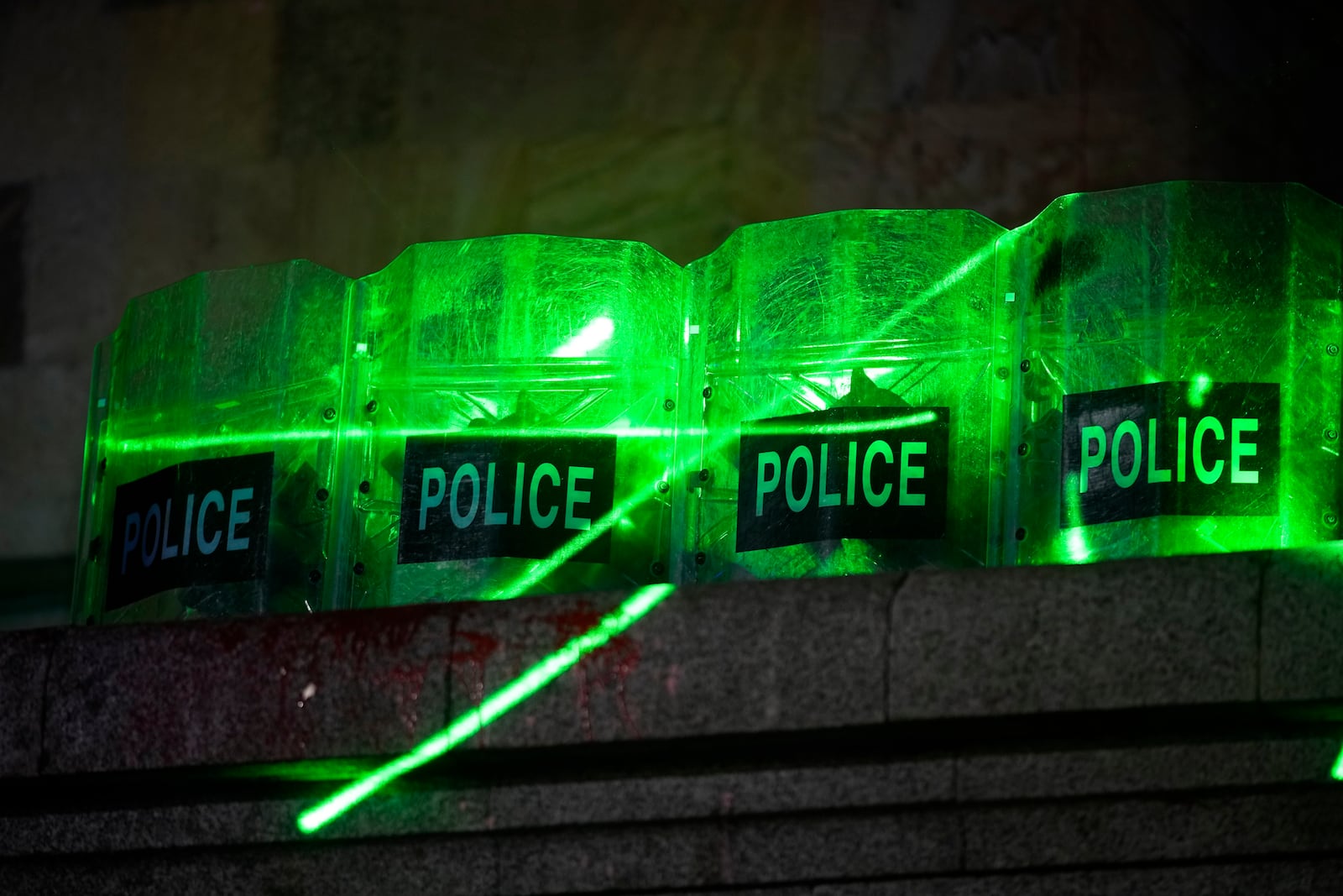 Demonstrators use laser flashlights against the police guarding the parliament's building during a rally to protest against the government's decision to suspend negotiations on joining the European Union in Tbilisi, Georgia, Tuesday, Dec. 3, 2024. (AP Photo/Pavel Bednyakov)