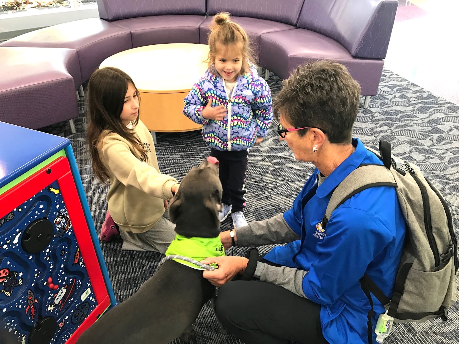 Yasira Nimateelah, a 9 ½ year old fourth grader from Tipp City, and her three year old sister Yara share some time with Dash and Chris Hart before Yasira’s follow up visit with her doctor.  Tom Archdeacon/CONTRIBUTED