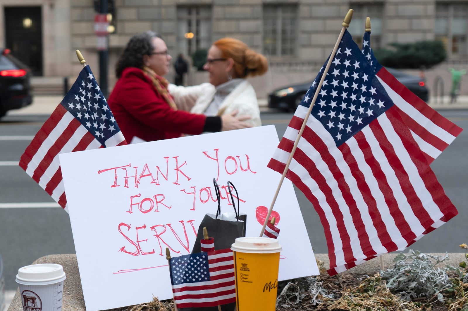 Flags and a sign thanking United States Agency for International Development (USAID) workers are pictured as USAID workers retrieve their personal belongings from USAID's headquarters in Washington, Thursday, Feb. 27, 2025, in Washington. (AP Photo/Manuel Balce Ceneta)