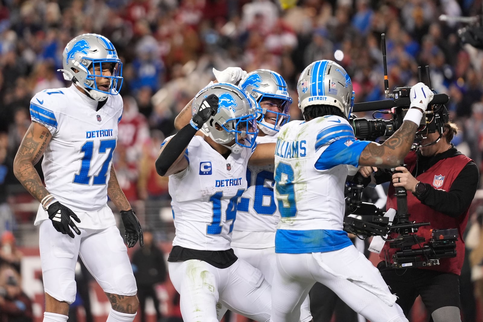 Detroit Lions wide receiver Amon-Ra St. Brown (14) celebrates his touchdown catch with teammate during the second half of an NFL football game Monday, Dec. 30, 2024, in Santa Clara, Calif. (AP Photo/Godofredo A. Vásquez)