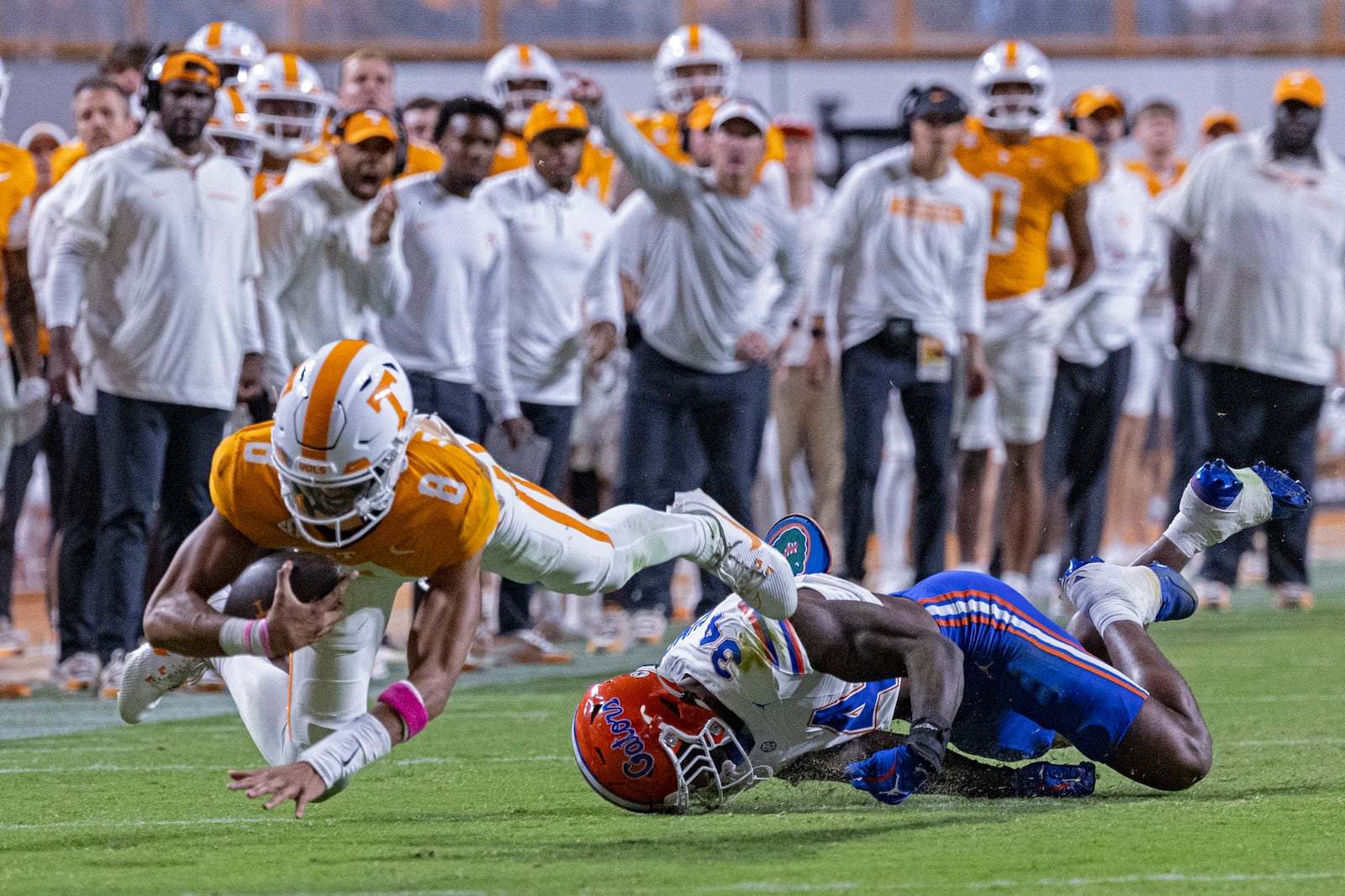 Tennessee quarterback Nico Iamaleava (8) dives for yardage as he's tackled by Florida edge George Gumbs Jr. (34) during the second half of an NCAA college football game, Saturday, Oct. 12, 2024, in Knoxville, Tenn. (AP Photo/Wade Payne)