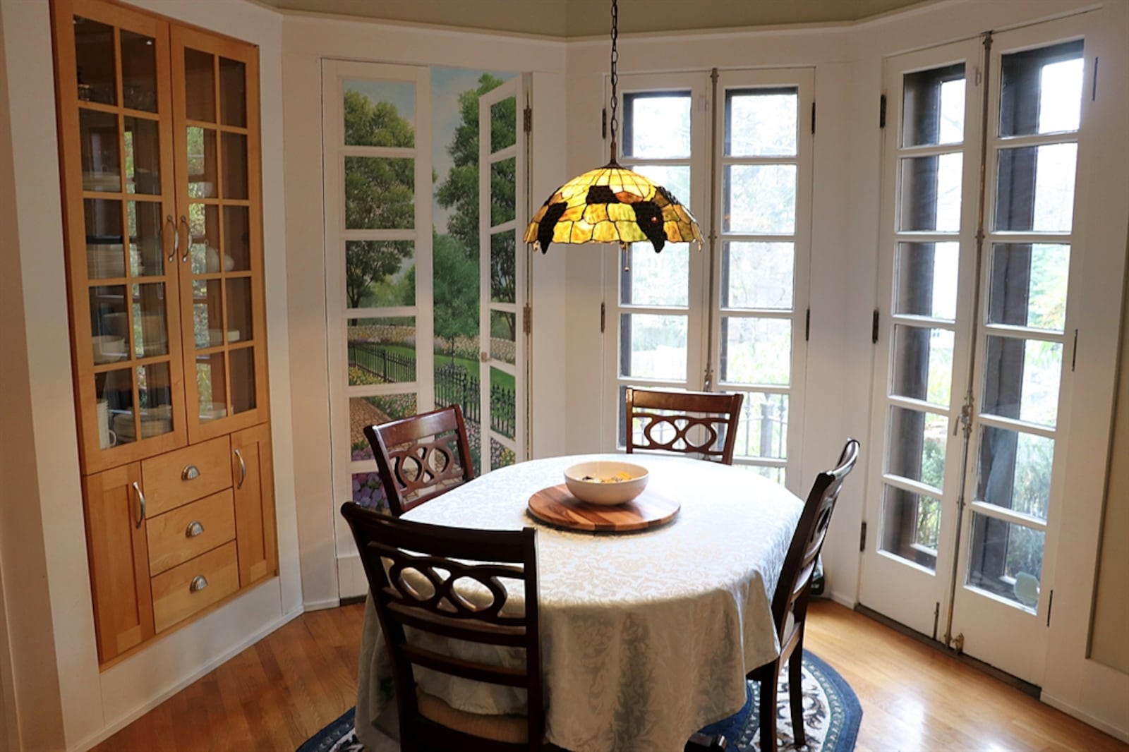 The bay-like breakfast room has French patio doors that open to the upper paver-brick patio. Along one wall of the breakfast room is a built-in china hutch with lighted shelves behind glass-panel doors.