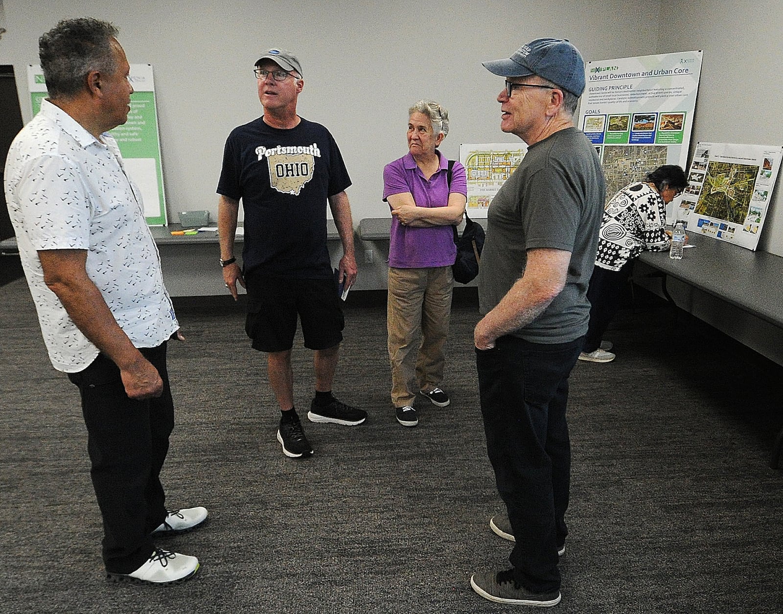 Xenia residents, from left, James Crawford, Steve Cuff, Beth Cuff and Nelson King discuss "neXtPlan" (a 10-year roadmap for Xenia development) at a open house Tuesday, April 16, 2024 at the Greene County media room. MARSHALL GORBY\STAFF