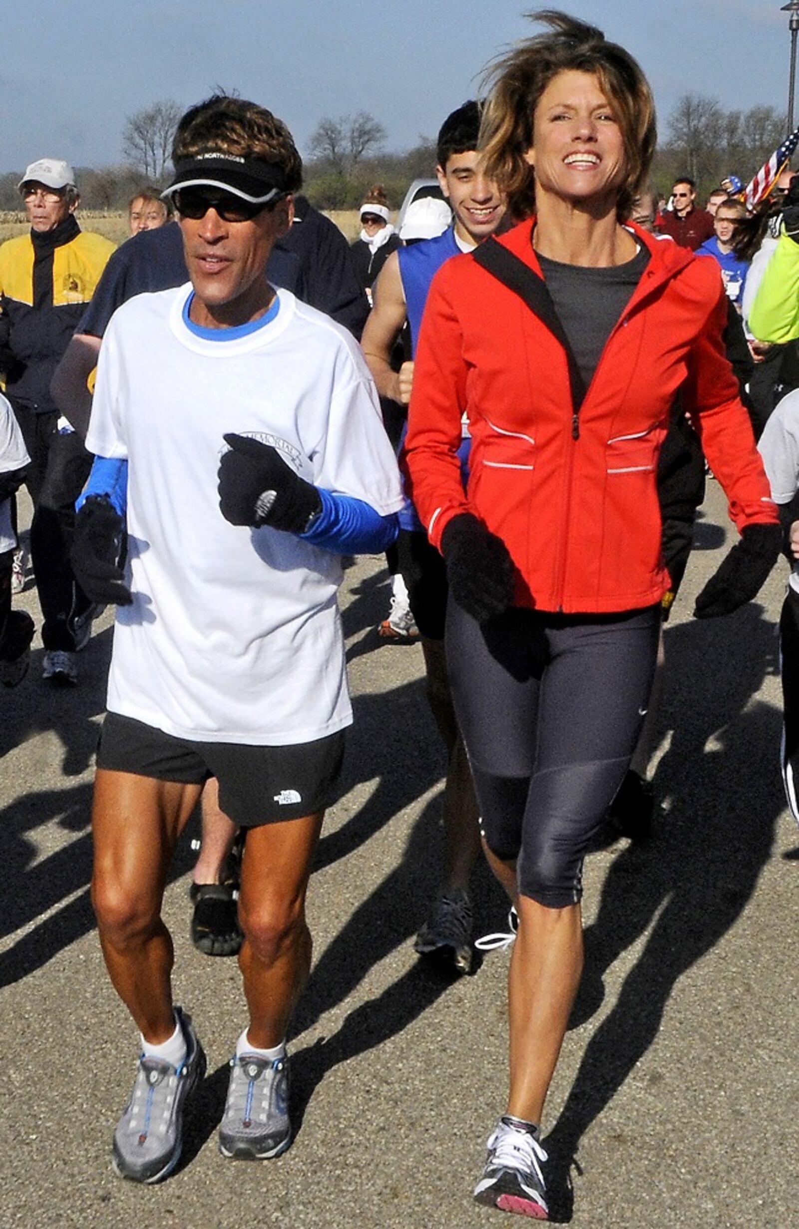 Famed ultramarathoner Dean Karnazes, runs with Karen Waldbillig Kasich, wife of Governor John Kasich. Karnazes hosted a 5K in Springfield with more than 300 runners, including 130 kids from Reid Primary and Middle schools, on Thursday, April 21, 2011. Staff photo by Marshall Gorby