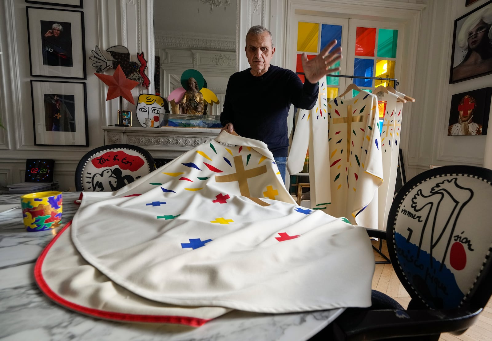 Designer Jean-Charles de Castelbajac displays a liturgical vestment for bishops to be worn at the reopening of Paris' Notre Dame Cathedral in December during an interview with the Associated Press Wednesday, Nov. 20, 2024 in Paris. (AP Photo/Michel Euler)