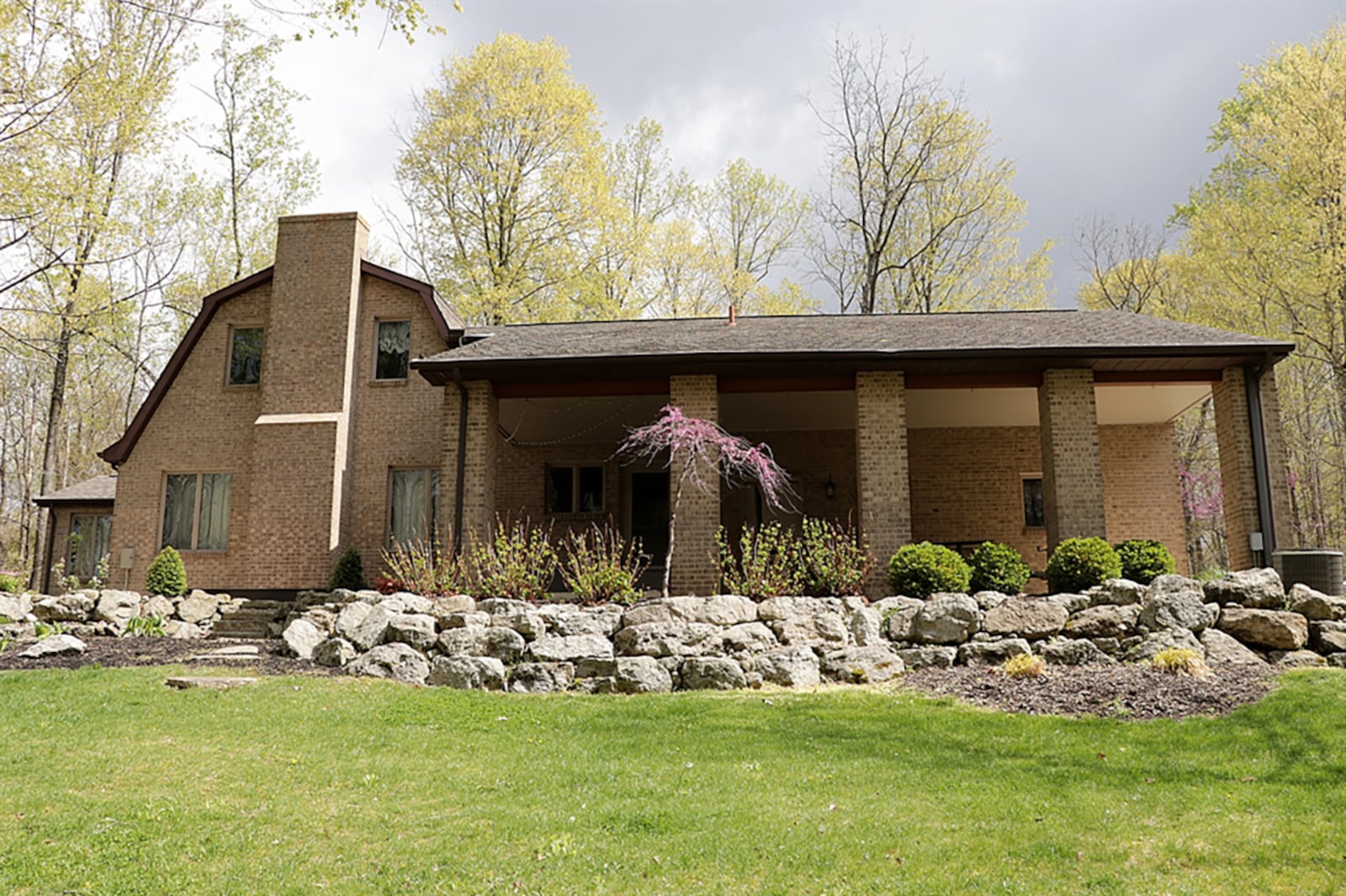 The brick house is surrounded by outdoor entertainment areas, including a concrete patio with electric for an optional hot tub area, a composite sun deck that extends to a covered porch or possible carport. There is a balcony wooden deck and a small concrete patio outside the basement door. CONTRIBUTED PHOTO BY KATHY TYLER