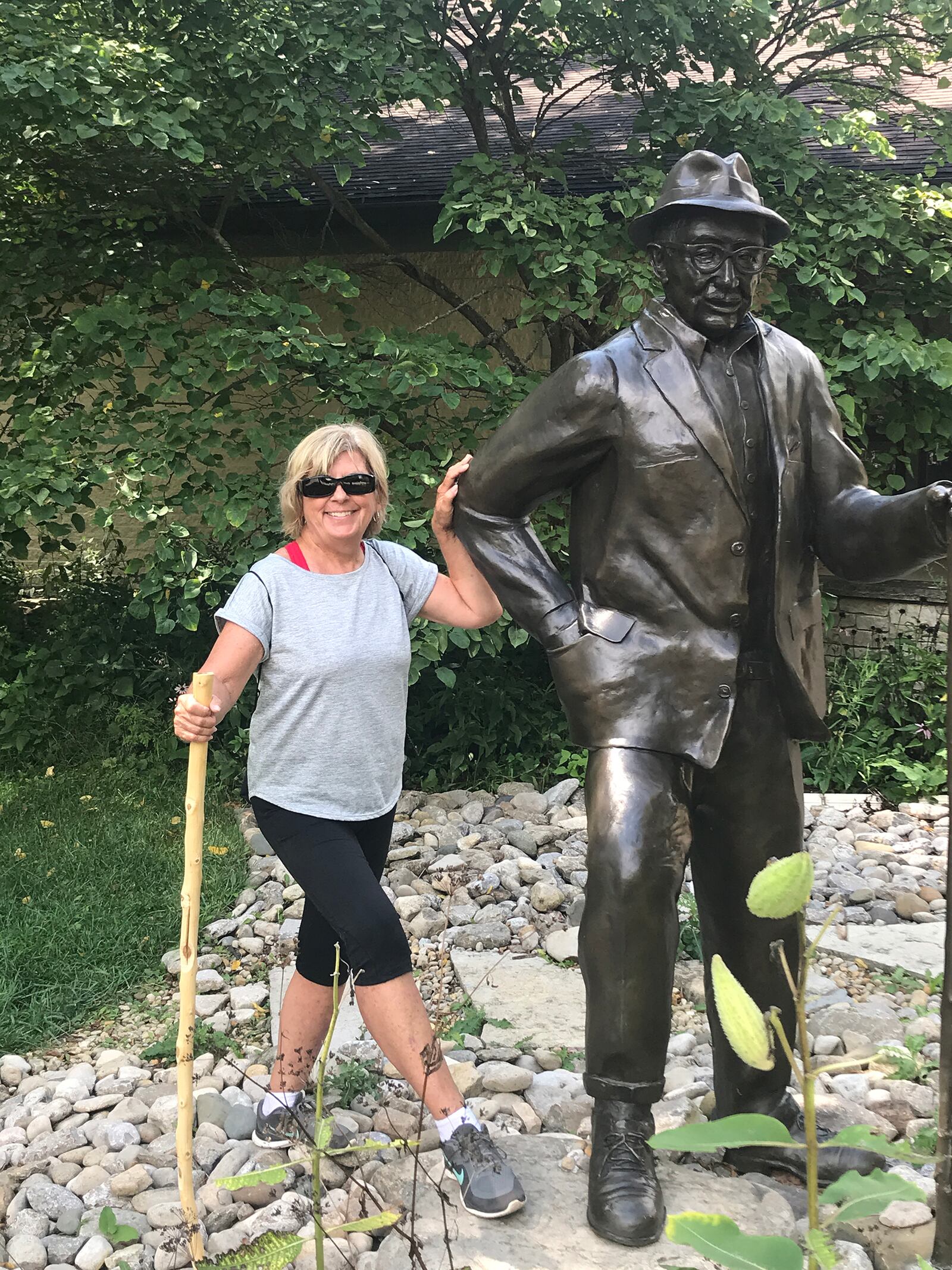 Barb Hess with the statue of Clayton Bruckner at Bruckner Nature Center. This Miami County park opened in 1974.