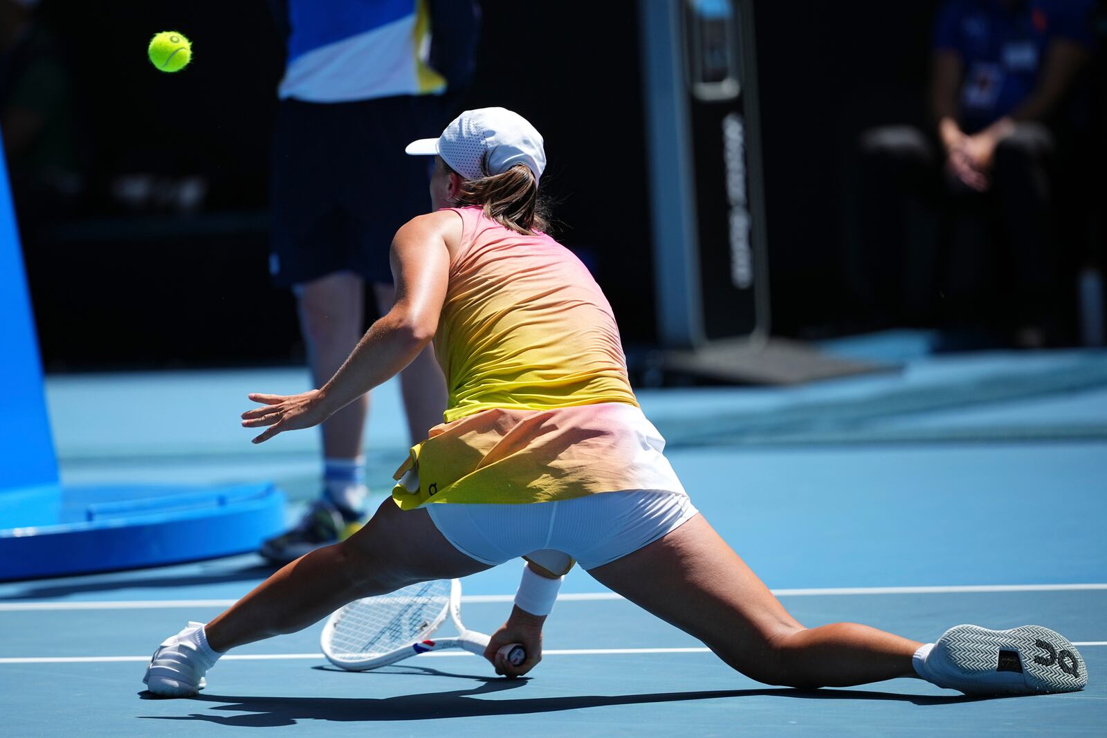 Iga Swiatek of Poland plays a forehand return to Emma Navarro of the U.S. during their quarterfinal match at the Australian Open tennis championship in Melbourne, Australia, Wednesday, Jan. 22, 2025. (AP Photo/Vincent Thian)