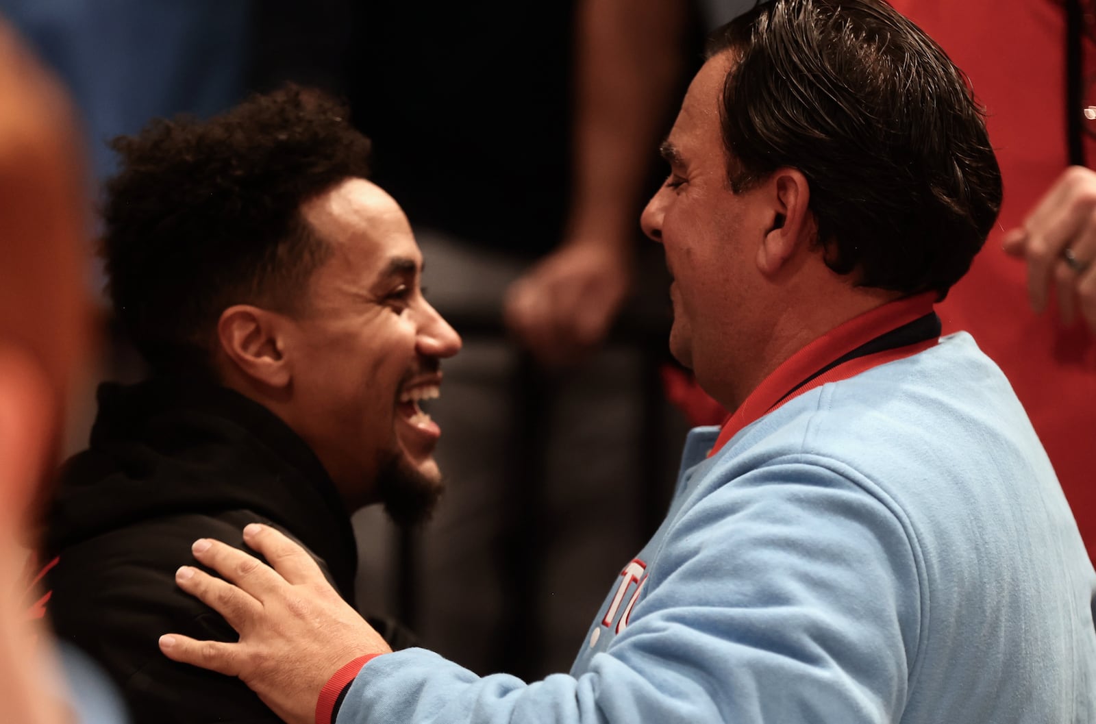 Former Flyer Brian Roberts, left, talks to UD fan Joe Maimone after a victory against Marquette on Saturday, Dec. 14, 2024, at UD Arena. David Jablonski/Staff