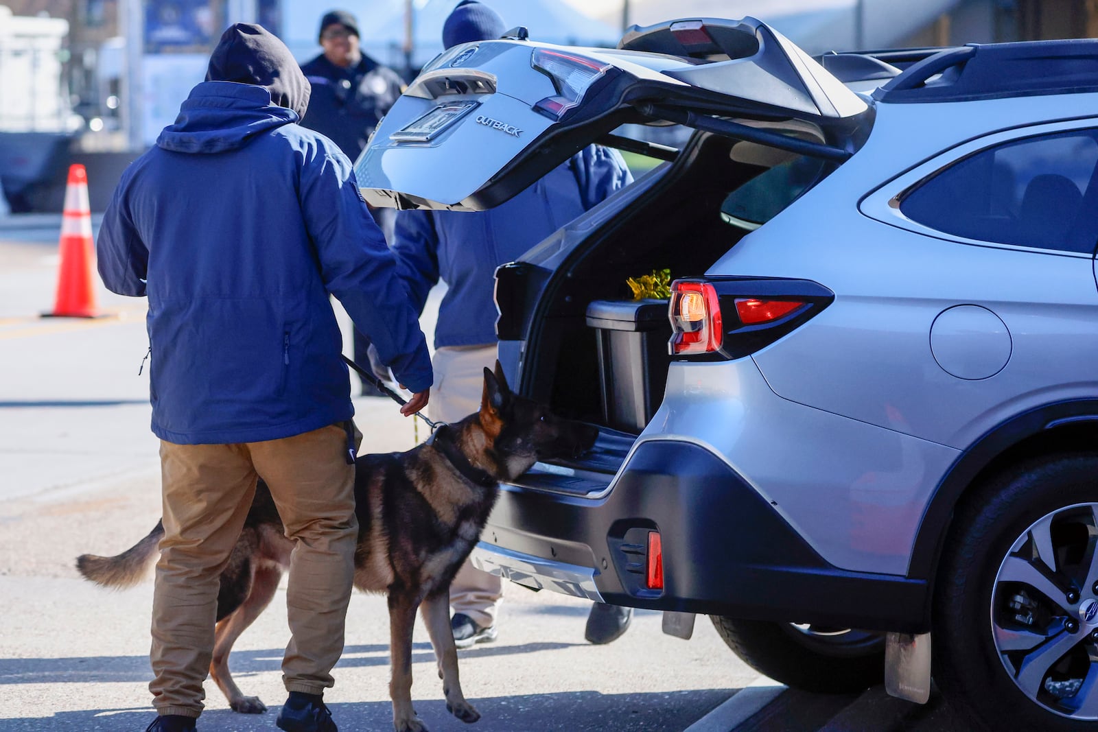 Security with bomb sniffing dogs check vehicles as they enter the Superdome ahead of the Sugar Bowl NCAA College Football Playoff game, Thursday, Jan. 2, 2025, in New Orleans. (AP Photo/Butch Dill)