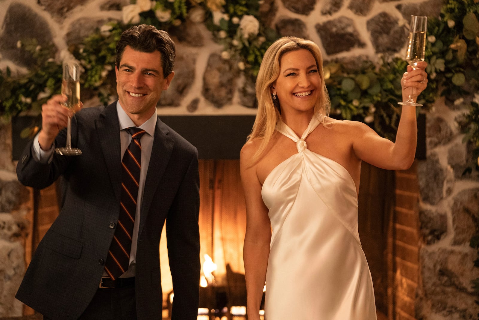 This image released by Netflix shows Max Greenfield as Lev Levinson, left, and Kate Hudson as Isla Gordon in "Running Point." (Katrina Marcinowski/Netflix via AP)