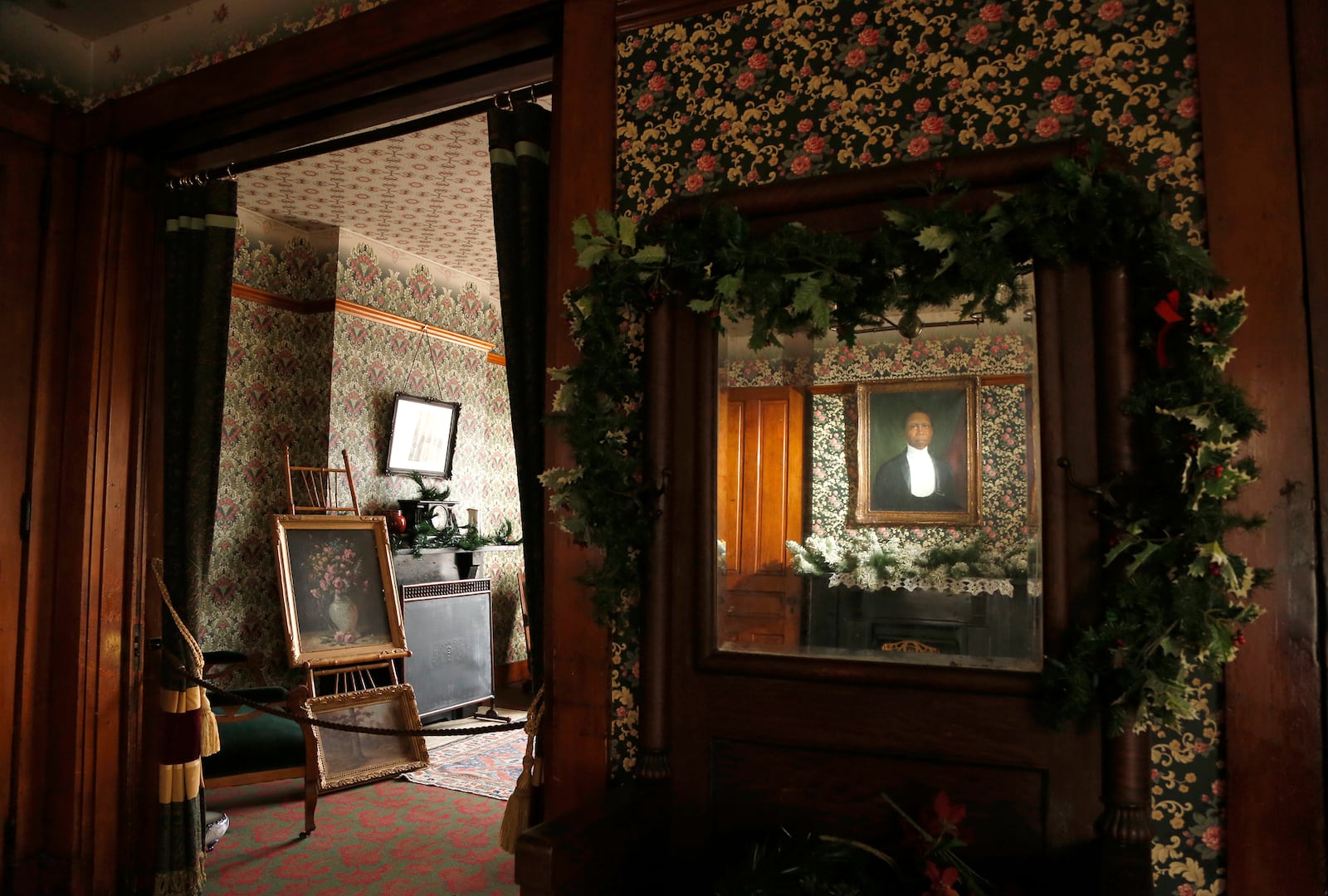 A formal parlor (left) is at the front of the Paul Laurence Dunbar House. A portrait of the poet, painted in 1904, hangs in a room used as an informal living area. LISA POWELL / STAFF