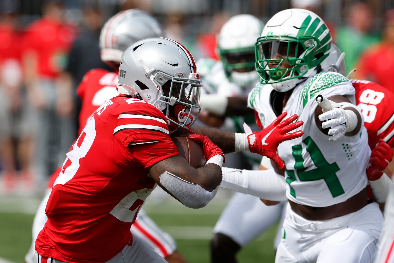 Ohio State running back Miyan Williams, left, tries to run past Oregon defensive lineman Bradyn Swinson during the first half of an NCAA college football game Saturday, Sept. 11, 2021, in Columbus, Ohio. Oregon beat Ohio State 35-28. (AP Photo/Jay LaPrete)