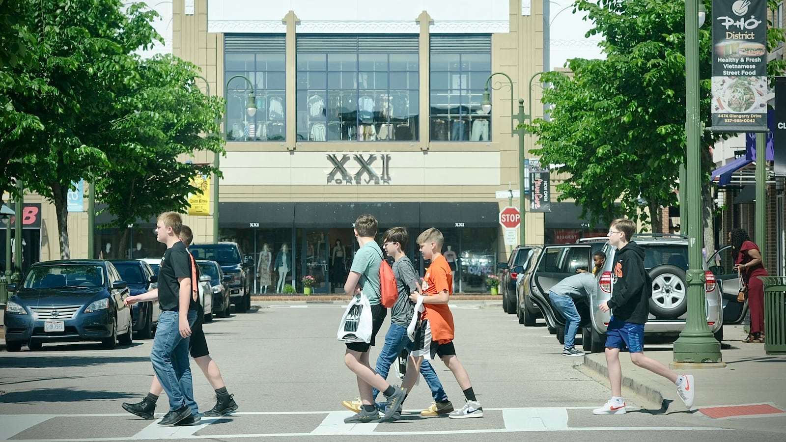 Young shoppers cross the street near the Forever 21 store at The Greene Town Center in Beavercreek on Tuesday, May 16, 2024. MARSHALL GORBY / STAFF