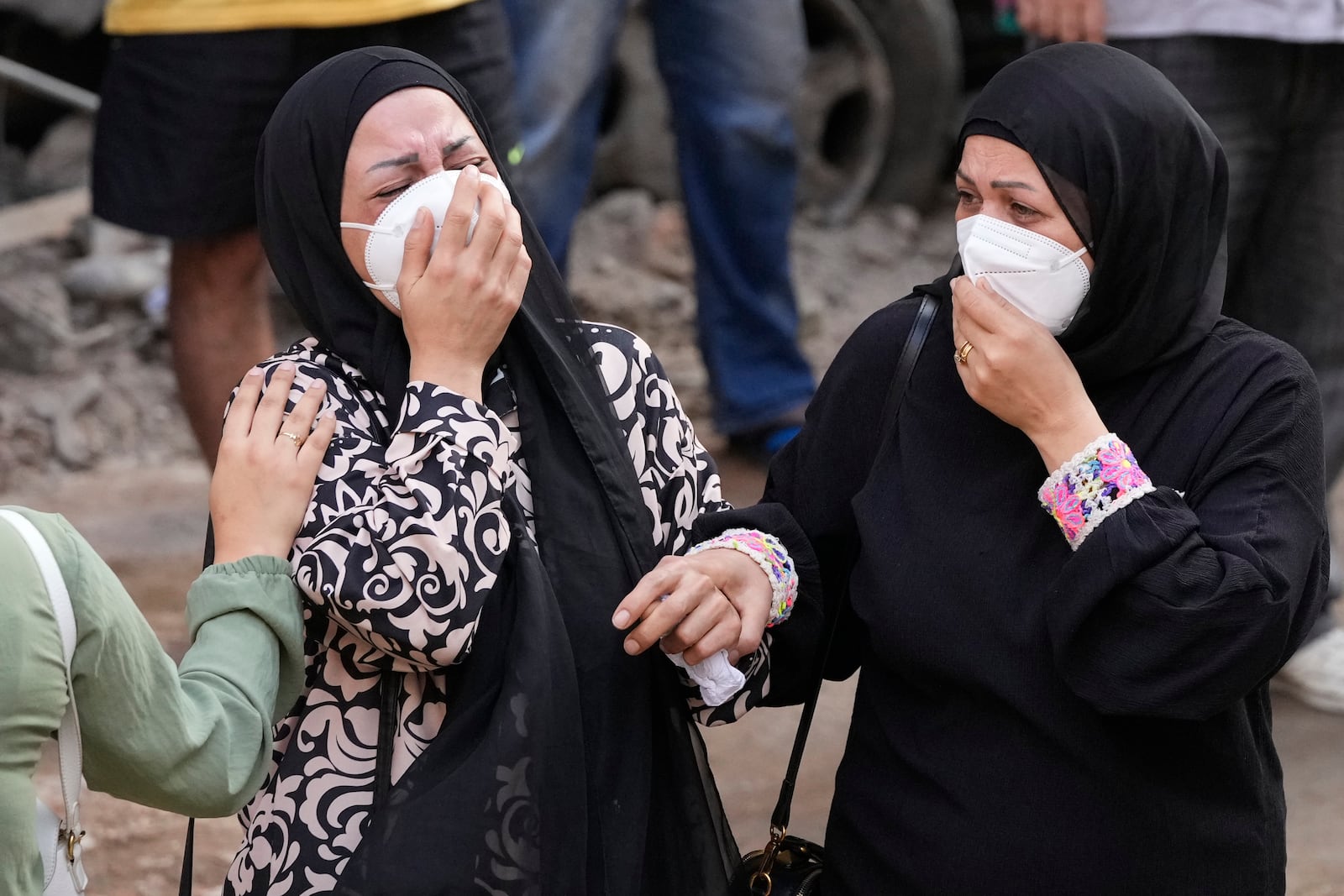 Women react in front of their destroyed apartment at the site of Thursday's Israeli airstrike in Beirut, Lebanon, Friday, Oct. 11, 2024. (AP Photo/Hassan Ammar)