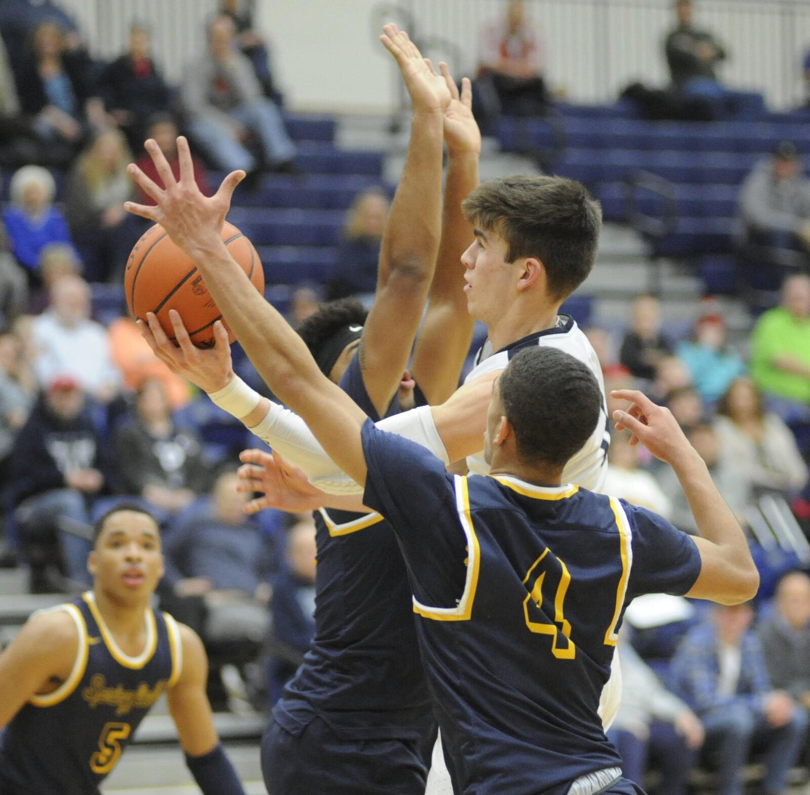 Ryan Hall of Fairmont (shooting) splits Springfield defenders Larry Stephens and David Sanford (4). Springfield defeated host Fairmont 71-40 in a boys high school basketball game at Trent Arena on Tuesday, Feb. 12, 2019. MARC PENDLETON / STAFF