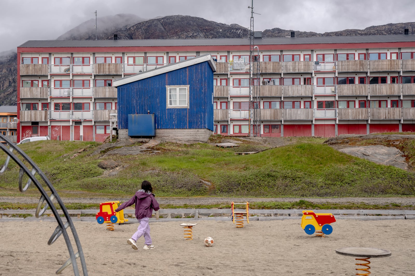 FILE - A child plays in front of a residential block in Sisimiut, Greenland, Tuesday, July 2, 2024. (Ida Marie Odgaard/Ritzau Scanpix via AP, File)