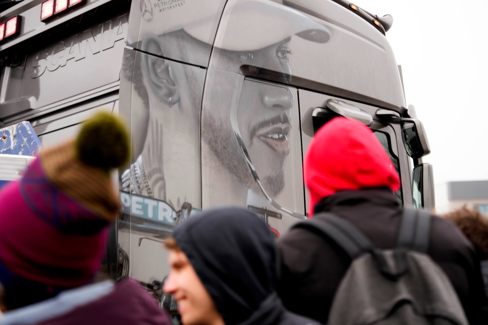 A truck runs displaying a paint of Lewis outside the Ferrari private test track, in Fiorano Modenese, Italy, Wednesday, Jan.22, 2025. (AP Photo/Luca Bruno)