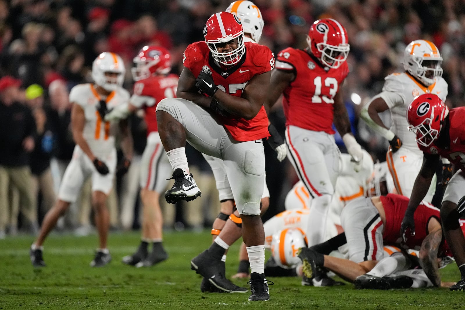 Georgia defensive lineman Warren Brinson (97) react after Bulldogs sacked Tennessee quarterback Nico Iamaleava (8) during the first half of an NCAA college football game, Saturday, Nov. 16, 2024, in Athens, Ga. (AP Photo/John Bazemore)