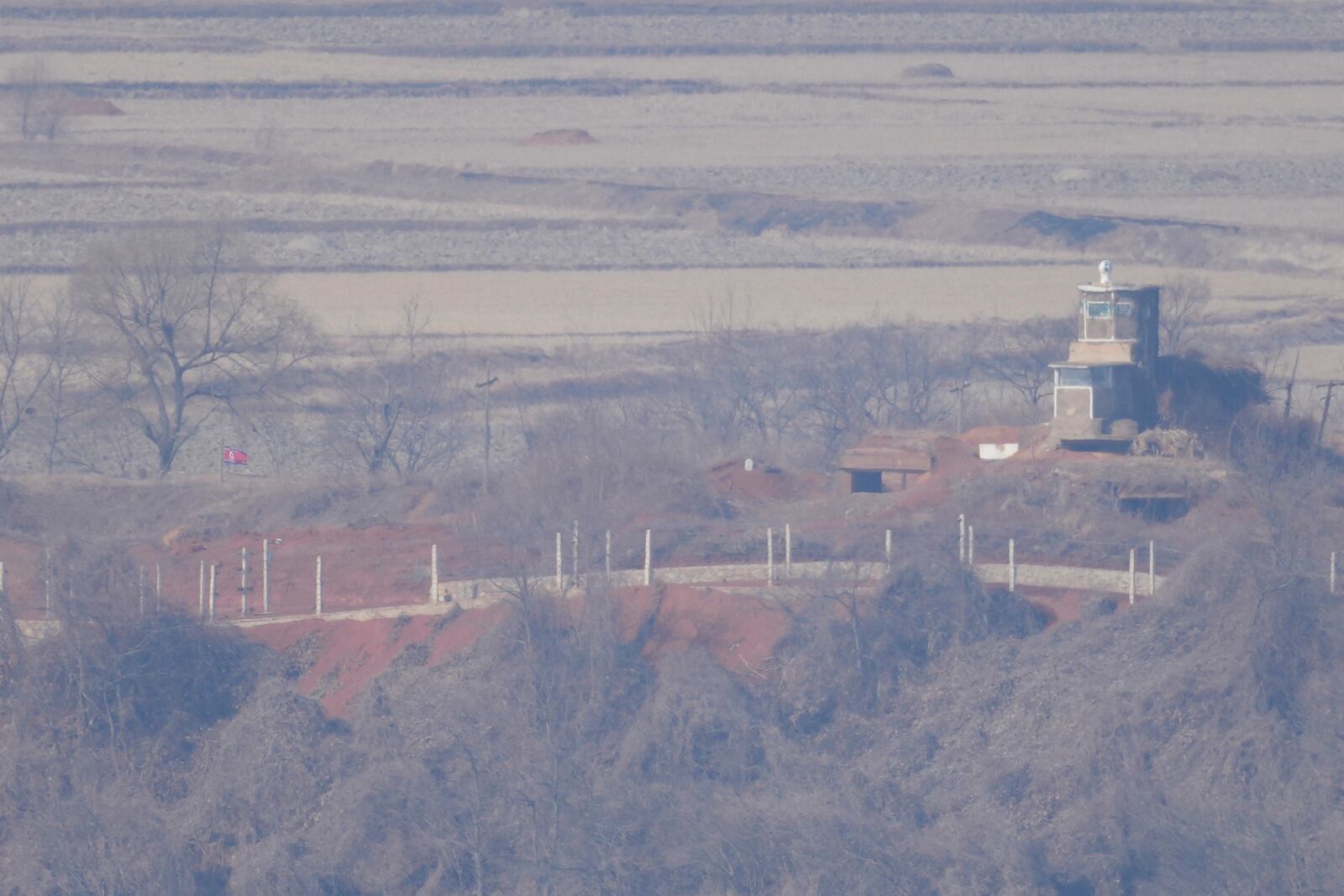 A North Korean flag flutters, left, near the military guard post, seen from the unification observatory in Paju, South Korea, Wednesday, Jan. 29, 2025. (AP Photo/Lee Jin-man)