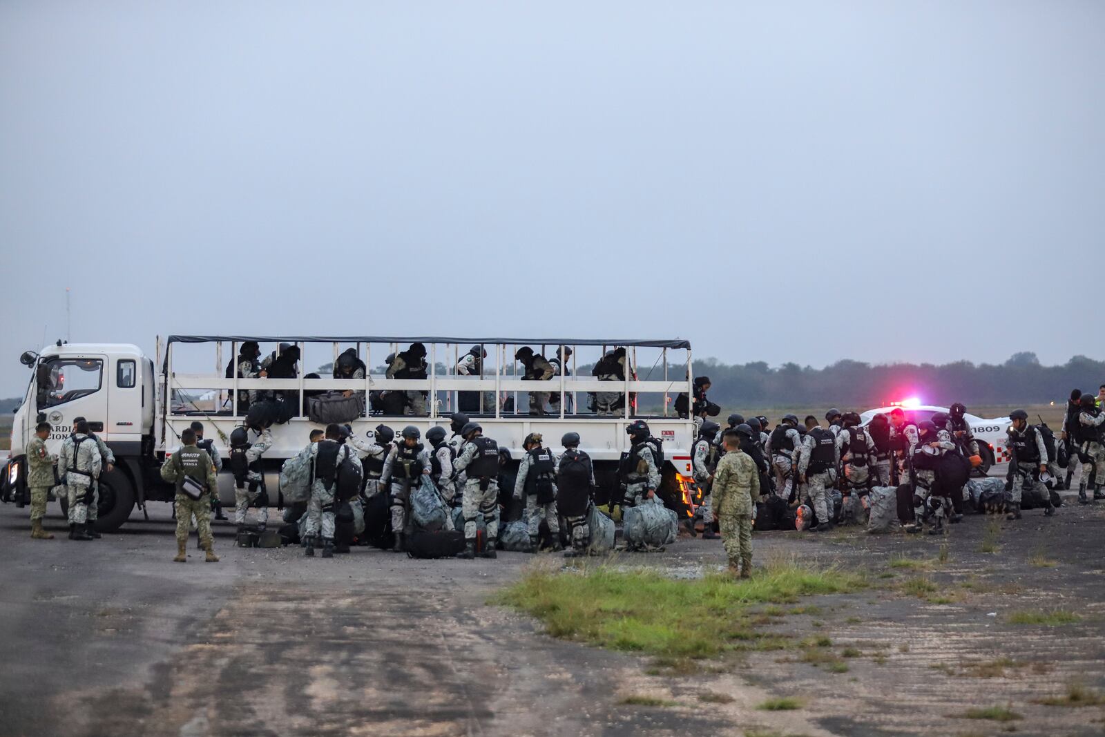 Mexican National Guards prepare to board an aircraft at the International Airport in Merida, Mexico, Tuesday, Feb. 4, 2025, to travel north to reinforce the country's border with the United States. (AP Photo/Martin Zetina)