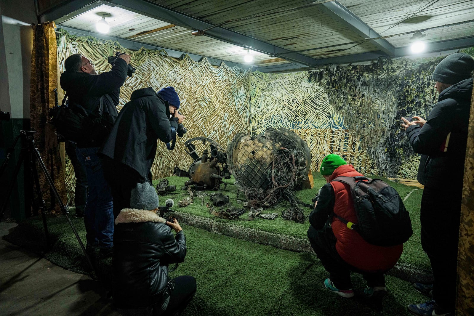 Journalists film fragments of a rocket which struck Dnipro on November 21, at a center for forensic analysis in undisclosed location, Ukraine, Sunday Nov. 24, 2024. (AP Photo/Evgeniy Maloletka)