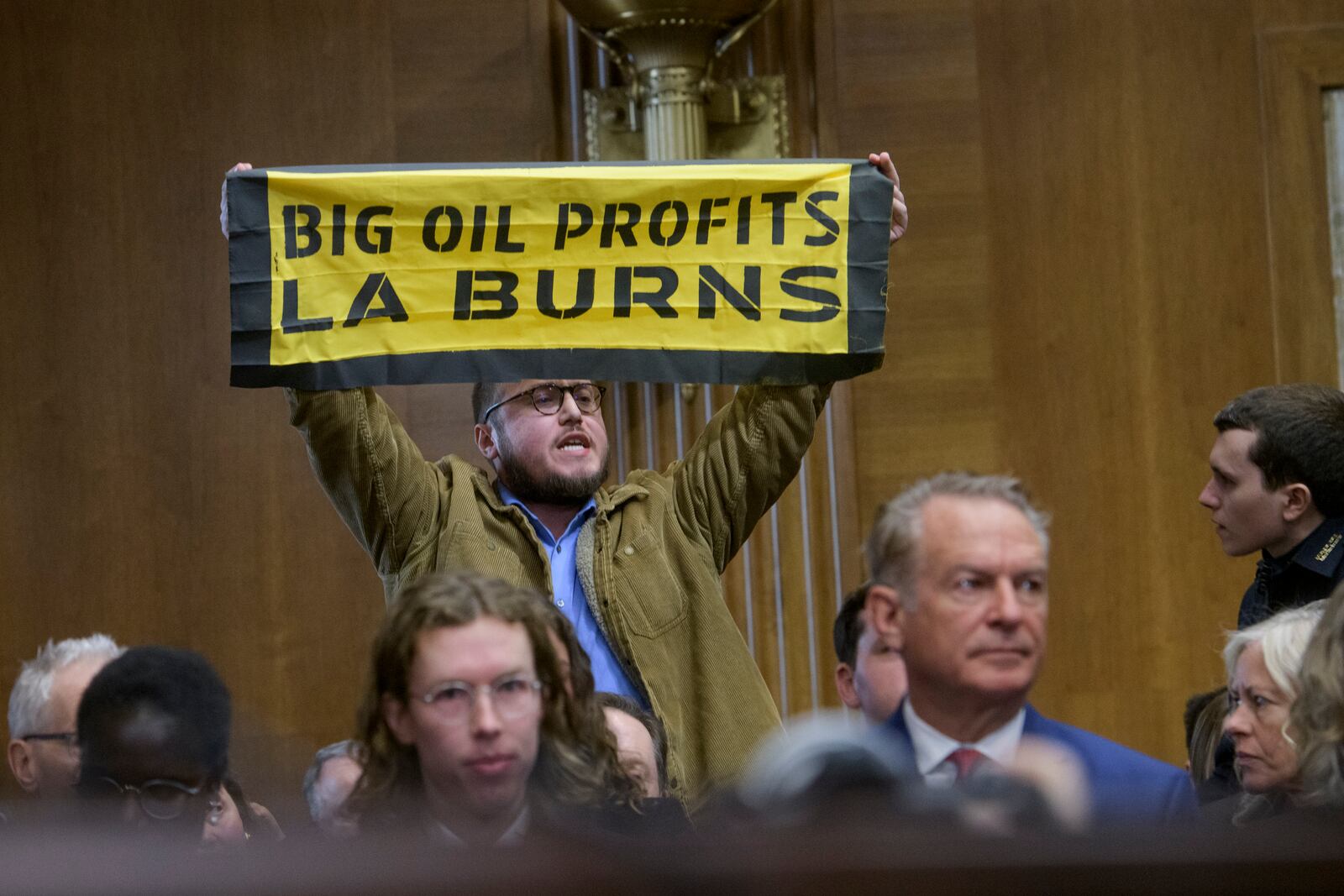 A protestor interrupts Chris Wright, President-elect Donald Trump's nominee to be Secretary of Energy, as he testifies during a Senate Committee on Energy and Natural Resources hearing for his pending confirmation, on Capitol Hill, Wednesday, Jan. 15, 2025, in Washington. (AP Photo/Rod Lamkey, Jr.)