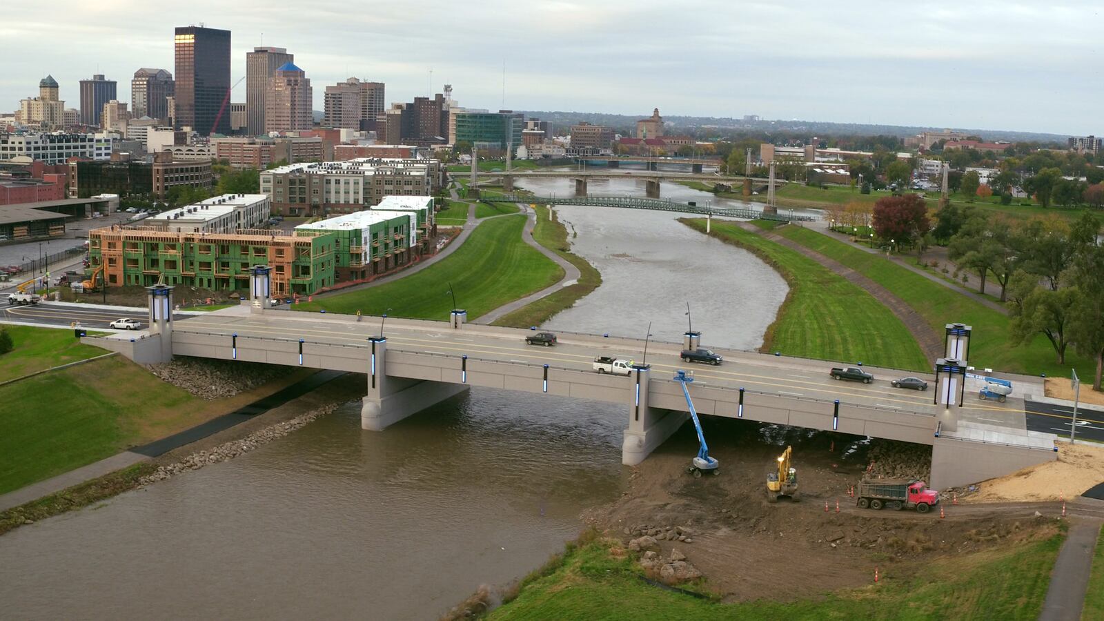 The $11 million Webster Street Bridge project is almost complete. Contractors worked to ready the concrete-spanned and lighted bridge on Thursday for a ribbon cutting ceremony officially opening the bridge which spans the Mad River.   TY GREENLEES / STAFF