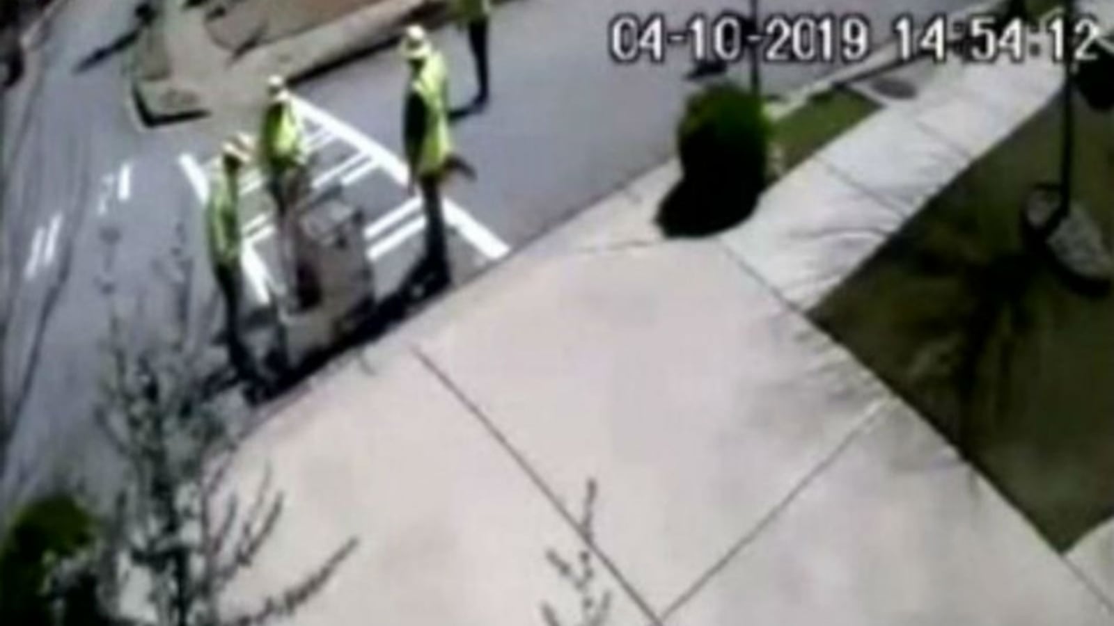 A crew paints a crosswalk leading to a man's driveway. (Photo: WSBTV.com)