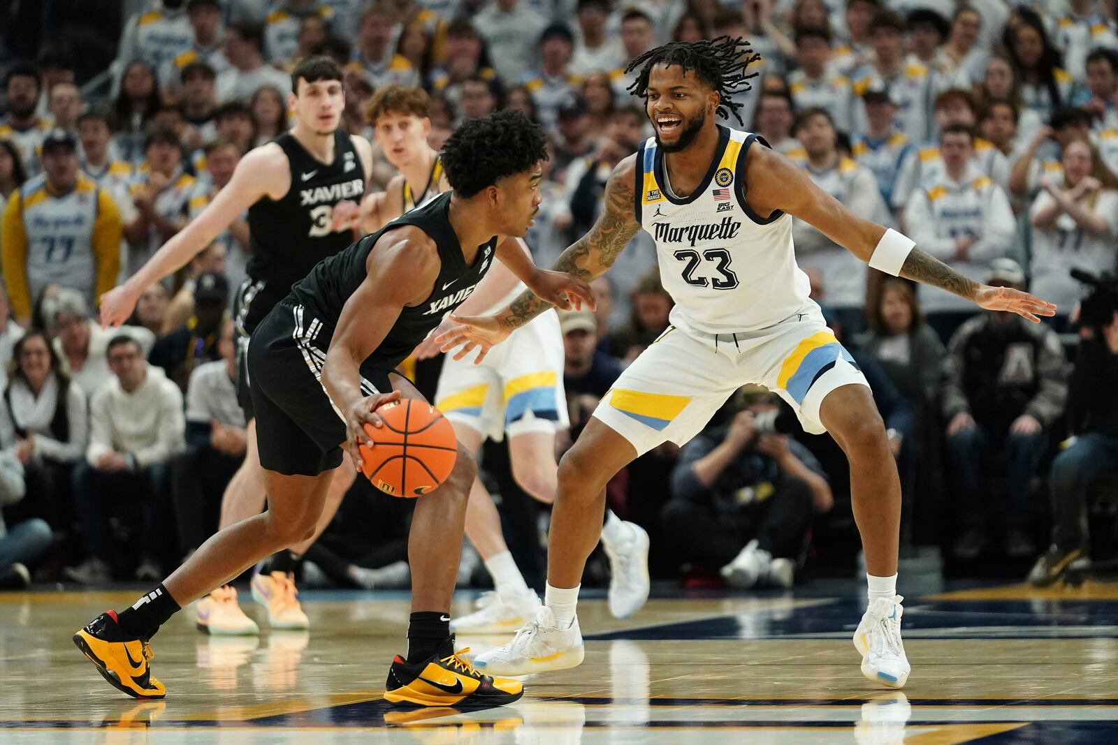 Marquette's David Joplin (23) defends against Xavier's Marcus Foster during the first half of an NCAA college basketball game Saturday, Jan. 18, 2025, in Milwaukee. (AP Photo/Aaron Gash)