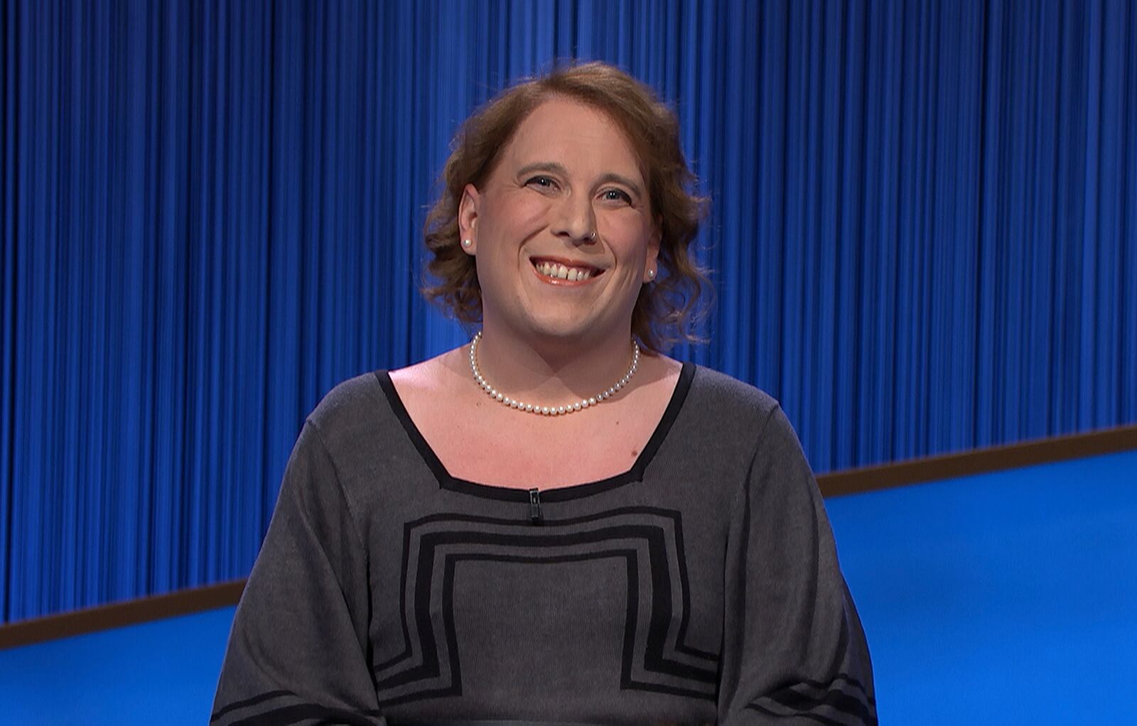 This image provided by Jeopardy Productions, Inc. shows game show champion Amy Schneider on the set of "Jeopardy!" Schneider is the first trans person to qualify for the show's Tournament of Champions. (Jeopardy Productions, Inc. via AP)