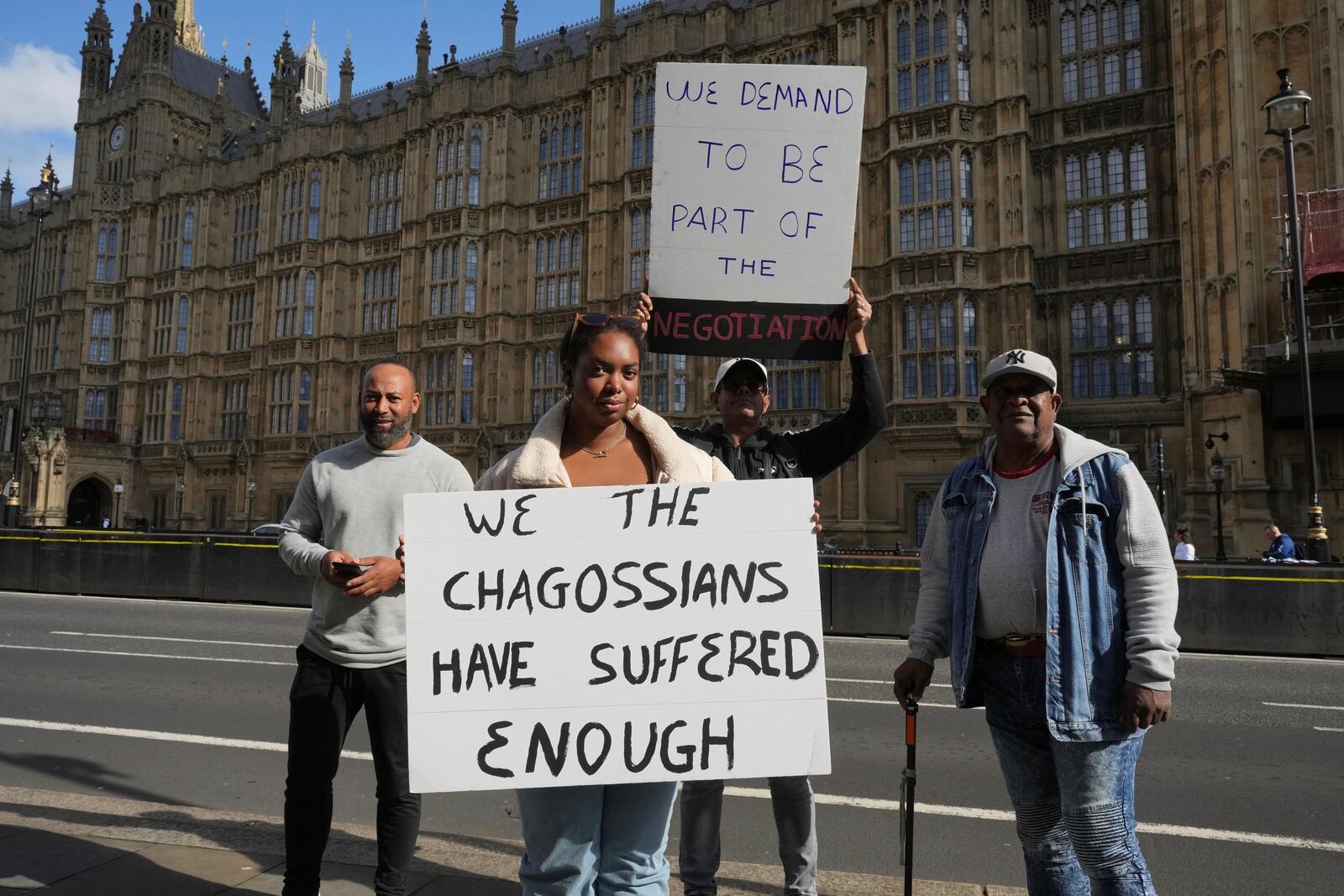 FILE - Chagossians Whitney Tranquille, center, attends a protest outside the House of Parliament, in London, Oct. 7, 2024. (AP Photo/Kin Cheung, file)