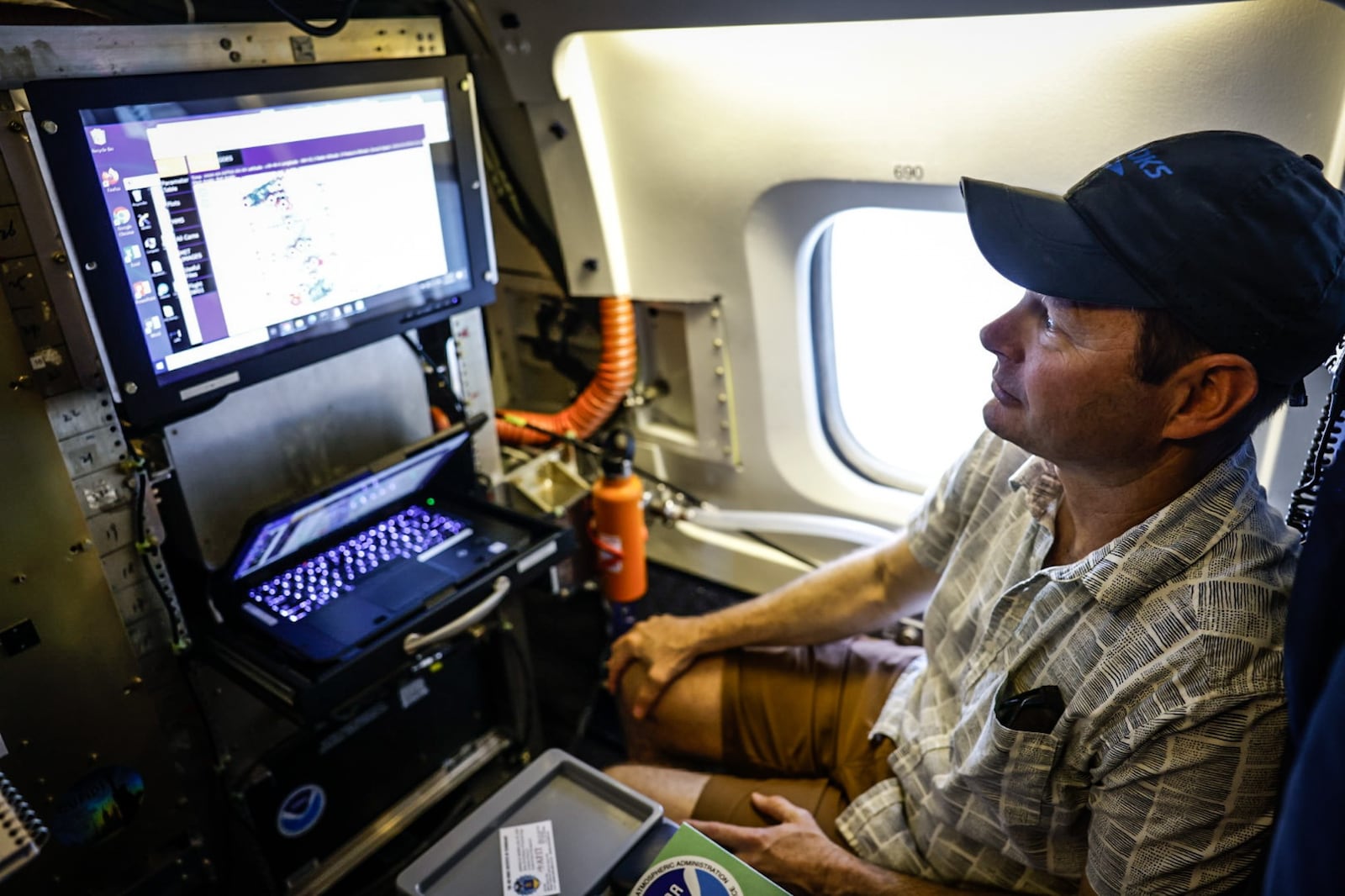 NOAA scientist, Charles Brock observes flight patterns of the DC-8 based at Wright Patt. JIM NOELKER/STAFF