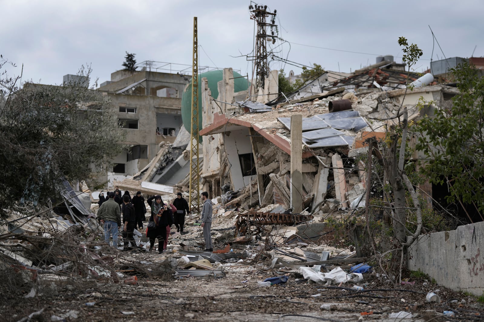 Lebanese citizens check the destruction in their village caused by the Israeli air and ground offensive, in Aita al-Shaab, a Lebanese border village with Israel, south Lebanon, Sunday, Jan. 26, 2025. (AP Photo/Bilal Hussein)