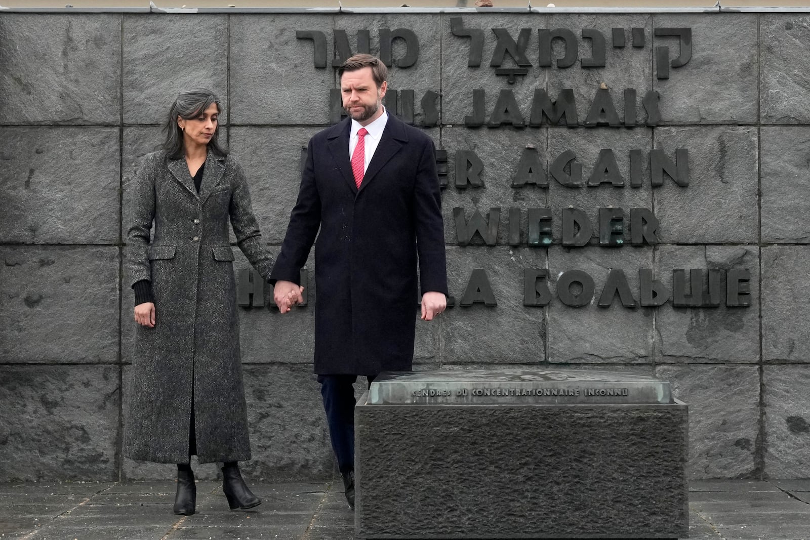 U.S. Vice President JD Vance and second lady Usha Vance walk away after pausing a moment by the urn with the ashes of the unknown prisoner at the Dachau Concentration Camp Memorial Site outside Munich, Germany, Thursday, Feb. 13, 2025. (AP Photo/Matthias Schrader)